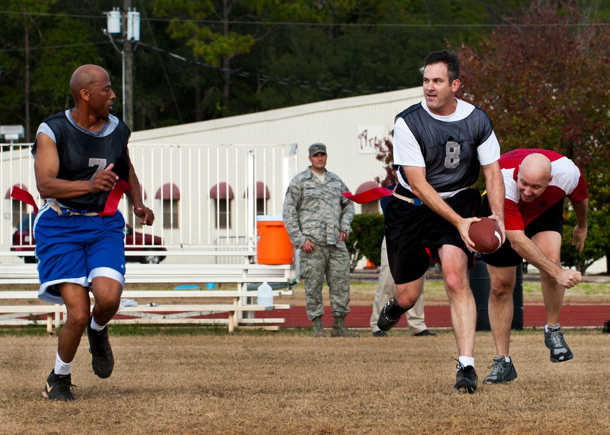 Andrew Toth looks to lateral a pass back to Tony Douglas during the annual Chiefs versus Eagles football game Nov. 22 at Eglin Air Force Base, Fla.  The Eagles avenged last year’s defeat by dominating the Chiefs 35-13.  (U.S. Air Force photo/Samuel King Jr.)