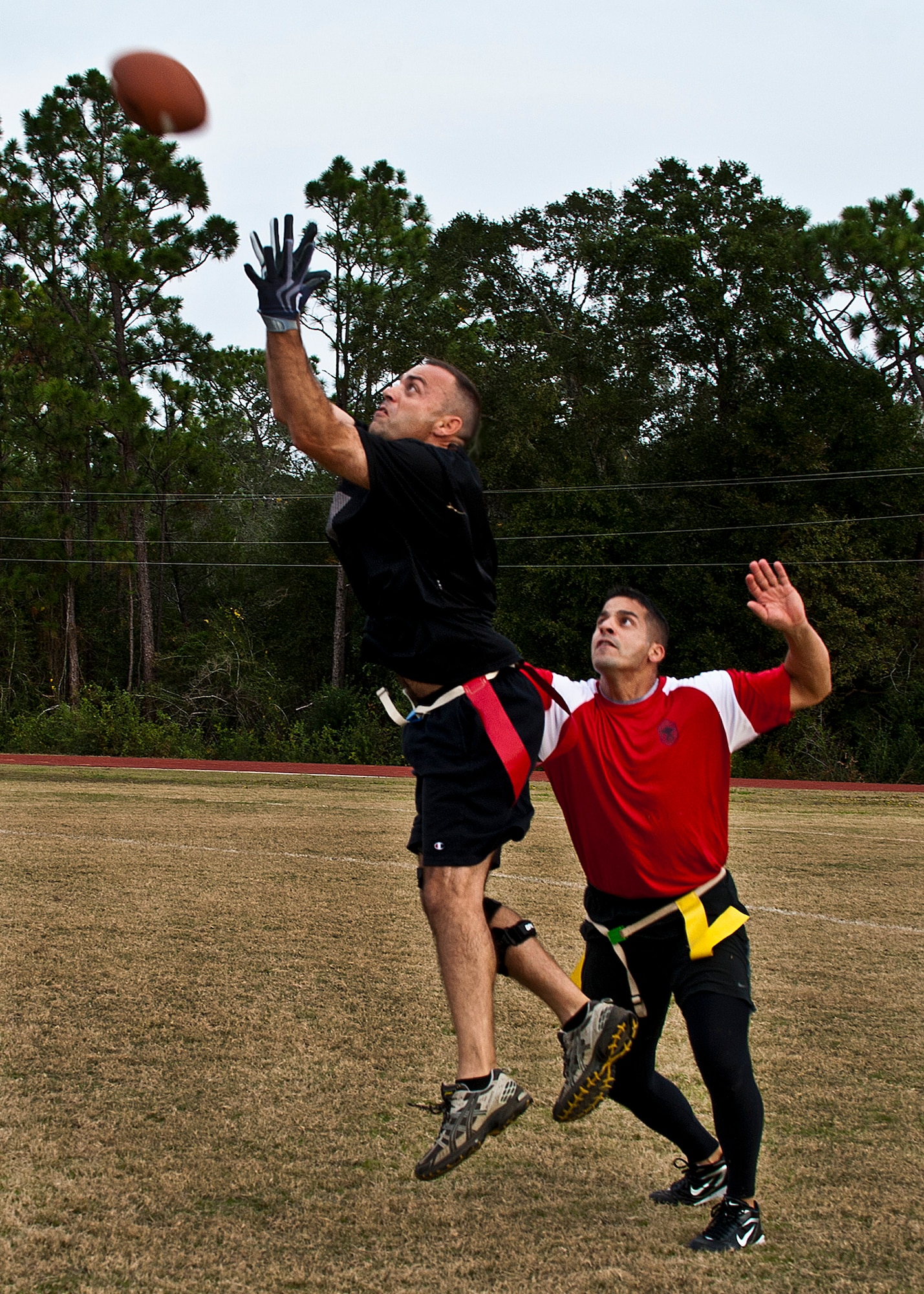 Sal Nodjomian goes up for a pass over Ben Caro during the annual Chiefs versus Eagles football game Nov. 22 at Eglin Air Force Base, Fla.  The Eagles avenged last year’s defeat by dominating the Chiefs 35-13.  (U.S. Air Force photo/Samuel King Jr.)