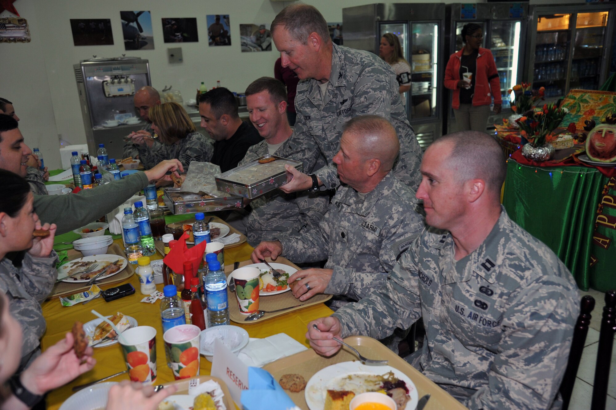 Air Expeditionary Wing Commander, Colonel Michael Zick, hands out cookies made by his mother during the Thanksgiving meal Nov. 24 at an undisclosed location in Southwest Asia (U.S. Air Force photo by Master Sgt. Carlotta Holley)