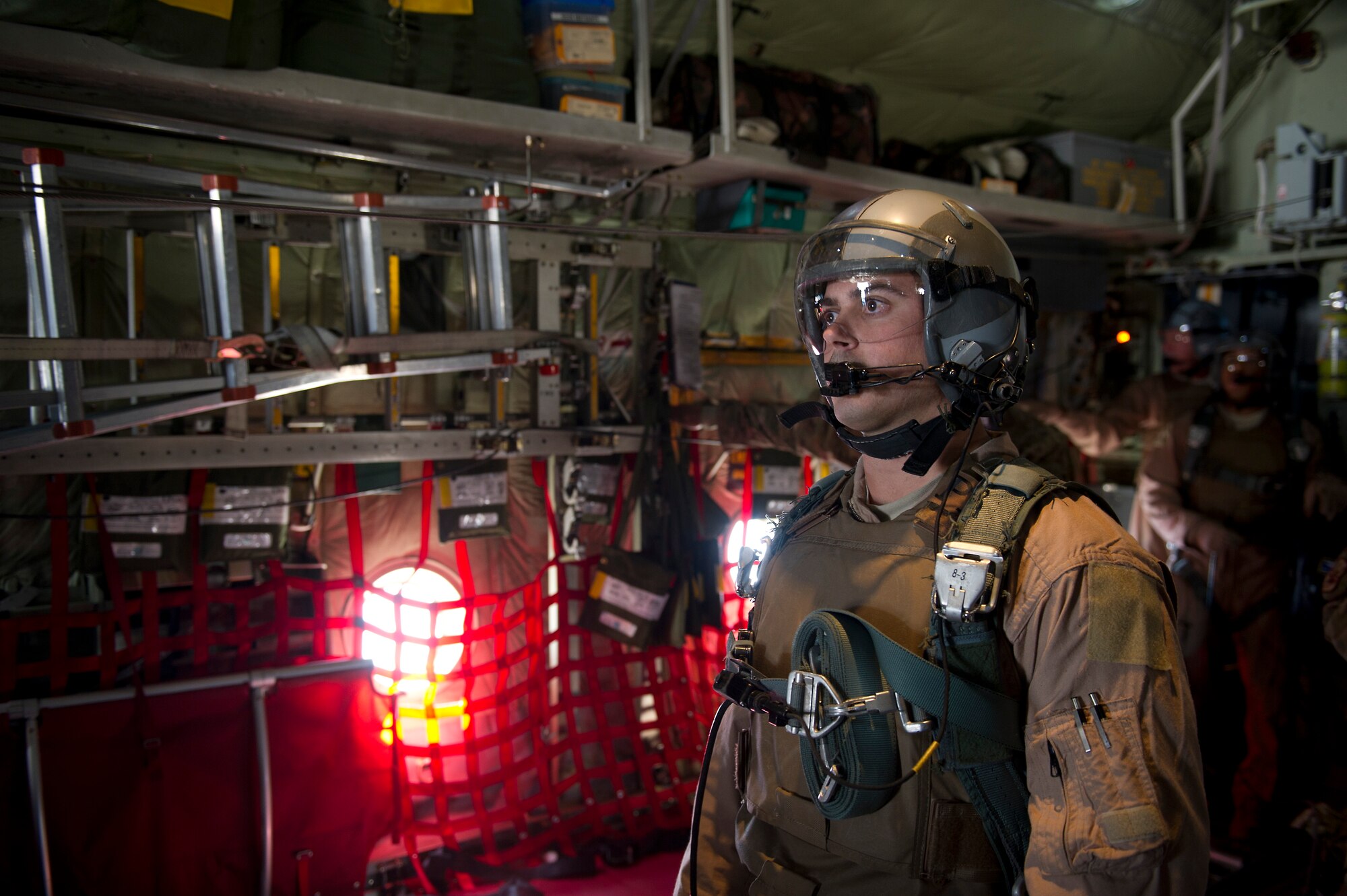 U.S. Air Force Staff Sgt. Steve Morris, loadmaster, waits for a signal to release a load of bundles from the back of a C-130 Hercules during an airdrop mission over Afghanistan on Nov. 23, 2011. Morris is deployed to Bagram Air Field, Afghanistan, from the 145th Air Wing, Air National Guard, Charlotte, N.C. (U.S. Air Force photo/Master Sgt. Jeffrey Allen)