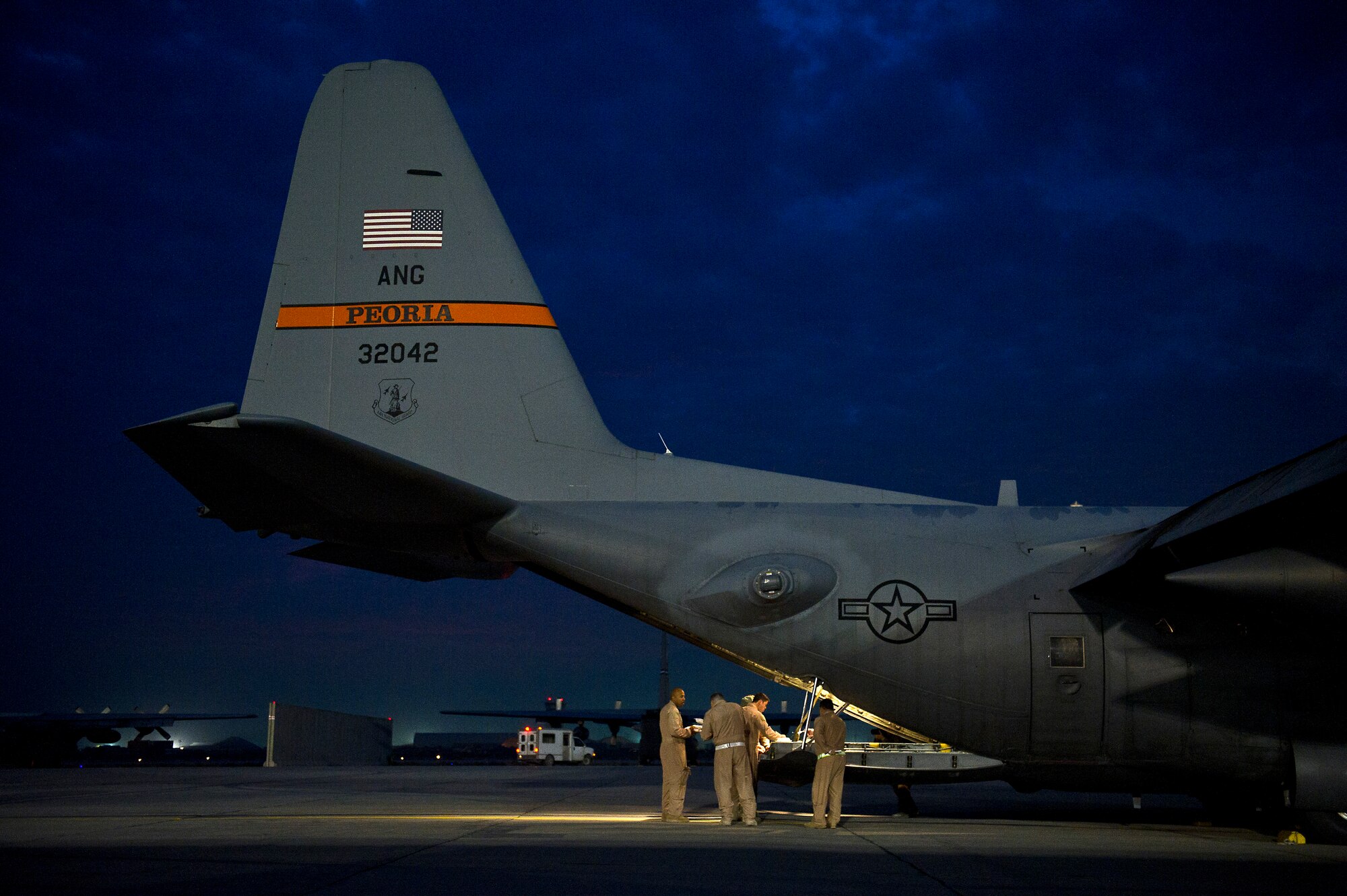 Members of the 774th Expeditionary Airlift Squadron eat breakfast around the ramp of a U.S. Air Force C-130 Hercules at Bagram Air Field, Afghanistan, before flying an airdrop mission on Nov. 23, 2011. The crew is deployed to Afghanistan from the 145th Air Wing, Air National Guard, Charlotte, N.C. (U.S. Air Force photo/Master Sgt. Jeffrey Allen)