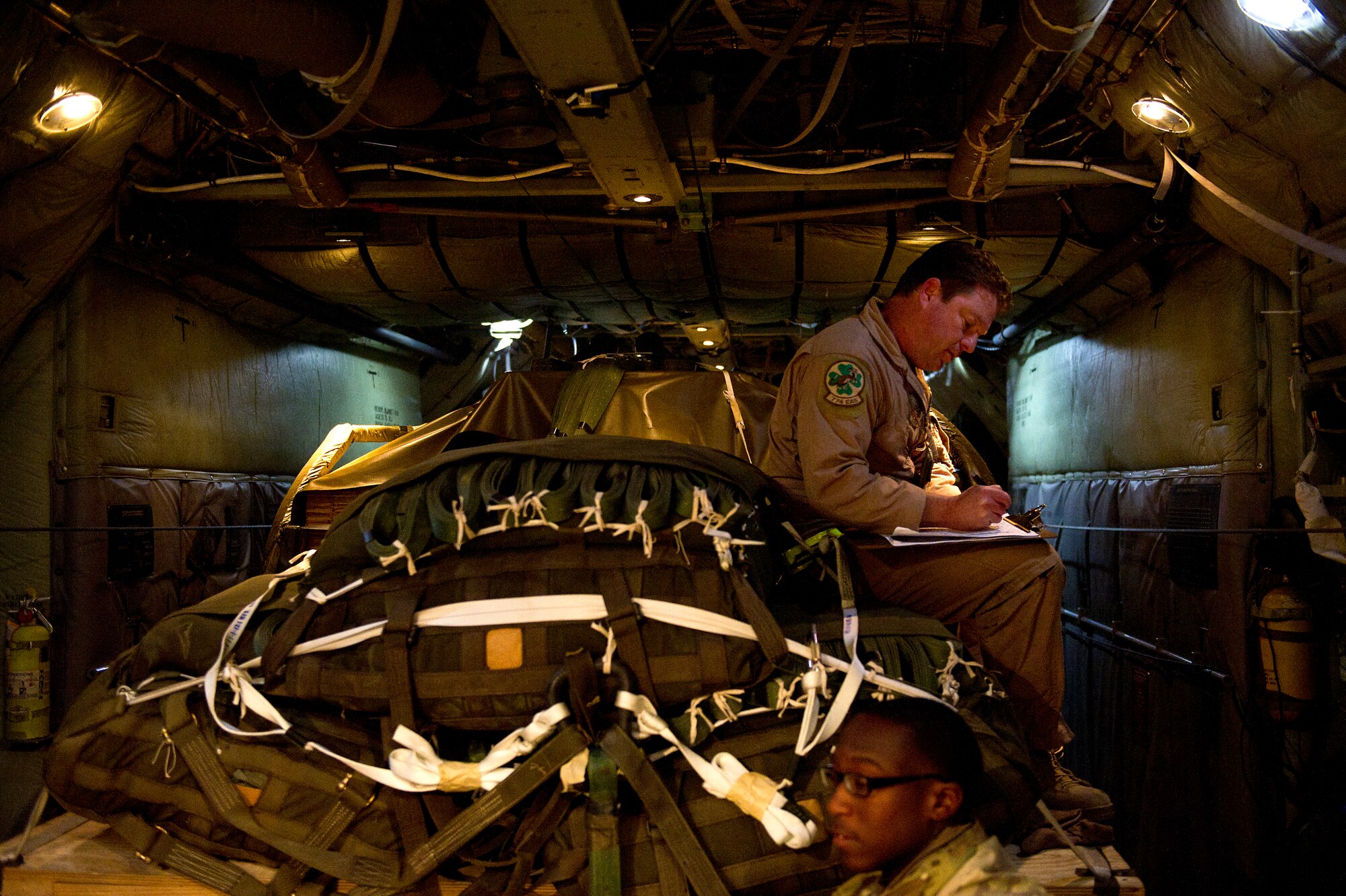 Senior Master Sgt. Todd White, 774th Expeditionary Airlift Squadron, Bagram Air Field, Afghanistan, inspects a forklift that is rigged to be airdropped from a C-130 Hercules on Nov. 23, 2011. White is inspecting  the load to ensure it is properly rigged so that it can be safely dropped. The forklift is being dropped to Soldiers at a remote base in eastern Afghanistan. (U.S. Air Force photo/Master Sgt. Jeffrey Allen)