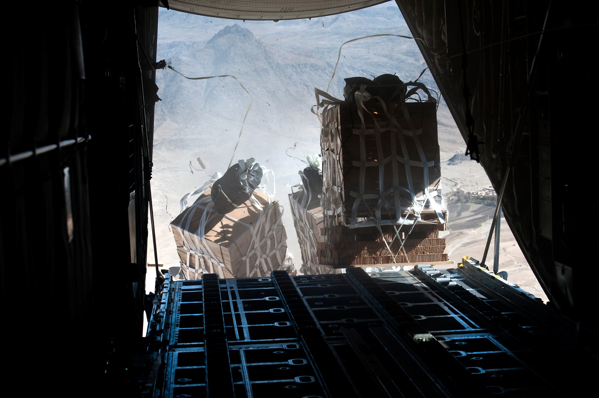 Pallets of food and supplies are being dropped from a U.S. Air Force C-130 Hercules from the 774th Expeditionary Airlift Squadron, Bagram Air Field, Afghanistan, on Nov. 23, 2011. The supplies are being delivered to Soldiers at a remote base near Kandahar, Afghanistan. (U.S. Air Force photo/Master Sgt. Jeffrey Allen)