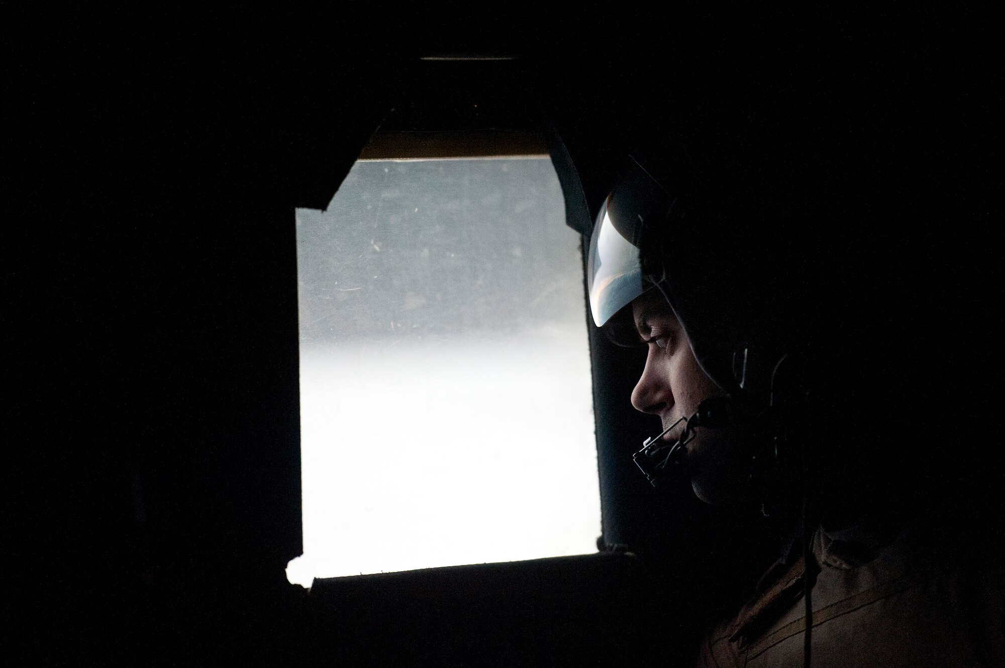 U.S. Air Force Staff Sgt. Steve Morris, loadmaster, scans for threats from a window in the back of a U.S. Air Force C-130 Hercules during an airdrop mission over Afghanistan on Nov. 23, 2011. Morris is deployed to Bagram Air Field, Afghanistan, from the 145th Air Wing, Air National Guard, Charlotte, N.C. (U.S. Air Force photo/Master Sgt. Jeffrey Allen)