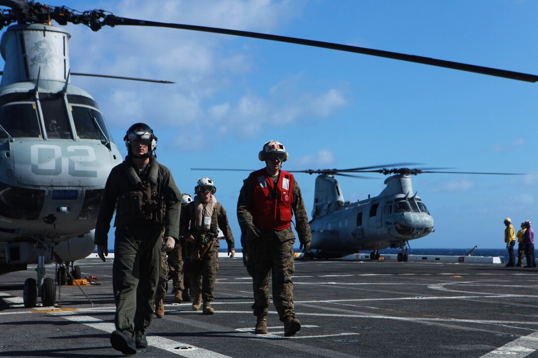 Marines with the 11th Marine Expeditionary Unit and sailors with USS New Orleans use a CH-46E Sea Knight with Marine Medium Helicopter Squadron 268 (Reinforced) to transfer personnel from ship to ship here Nov. 26. The squadron is the aviation combat element for the unit, which embarked USS Makin Island, USS New Orleans and USS Pearl Harbor in San Diego Nov. 14, for a seven-month deployment to the Western Pacific and Middle East regions.