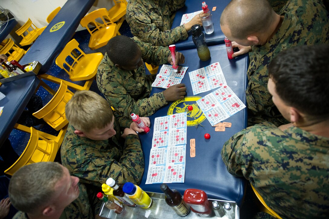 Marines and sailors with Combat Logistics Battalion 11 play bingo aboard USS Pearl Harbor here Nov. 26. The battalion provides logistics and services for the 11th Marine Expeditionary Unit, which embarked USS Makin Island, USS New Orleans and USS Pearl Harbor in San Diego Nov. 14, beginning a seven-month deployment to the Western Pacific and Middle East regions.