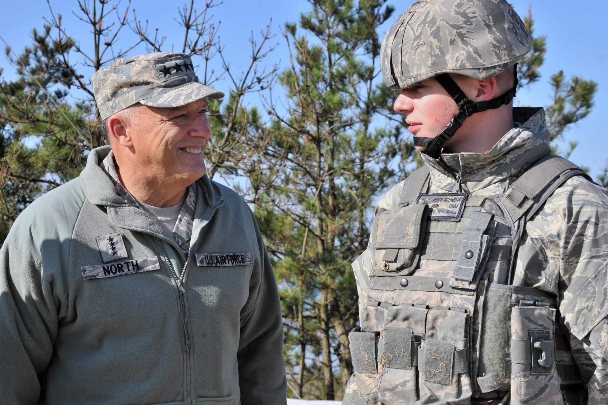 Gen. Gary North, Pacific Air Forces commander, speaks with Airman Jesse Schwenk, 8th Security Forces Squadron response force member, during a tour of Kunsan Air Base, Republic of Korea, Nov. 21. During his visit, the general received a mission briefing and an 8th SFS demonstration. (U.S. Air Force photo by Senior Airman Brittany Y. Auld/Released)