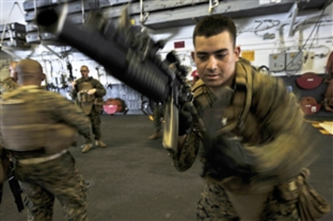 U.S. Marine Corps Cpl. Daniel Molina practices changing magazines aboard USS Makin Island Nov. 26, 2011. Molina is assigned to the 11th Marine Expeditionary Unit's Battalion Landing Team 3/1. The unit embarked USS Makin Island, USS New Orleans and USS Pearl Harbor in San Diego on Nov. 14 to begin a seven-month deployment to the Western Pacific and Middle East regions.