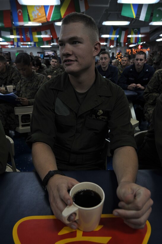 Lance Cpl. Mitchell A. Zgorzynski listens to karaoke aboard USS Makin Island here Nov. 26. Zgorzynski, an Aurora, Colo., native, serves with the 11th Marine Expeditionary UnitÃ?s combat cargo detachment. The unit embarked USS Makin Island, USS New Orleans and USS Pearl Harbor in San Diego Nov. 14 to begin a seven-month deployment to the Western Pacific and Middle East regions.