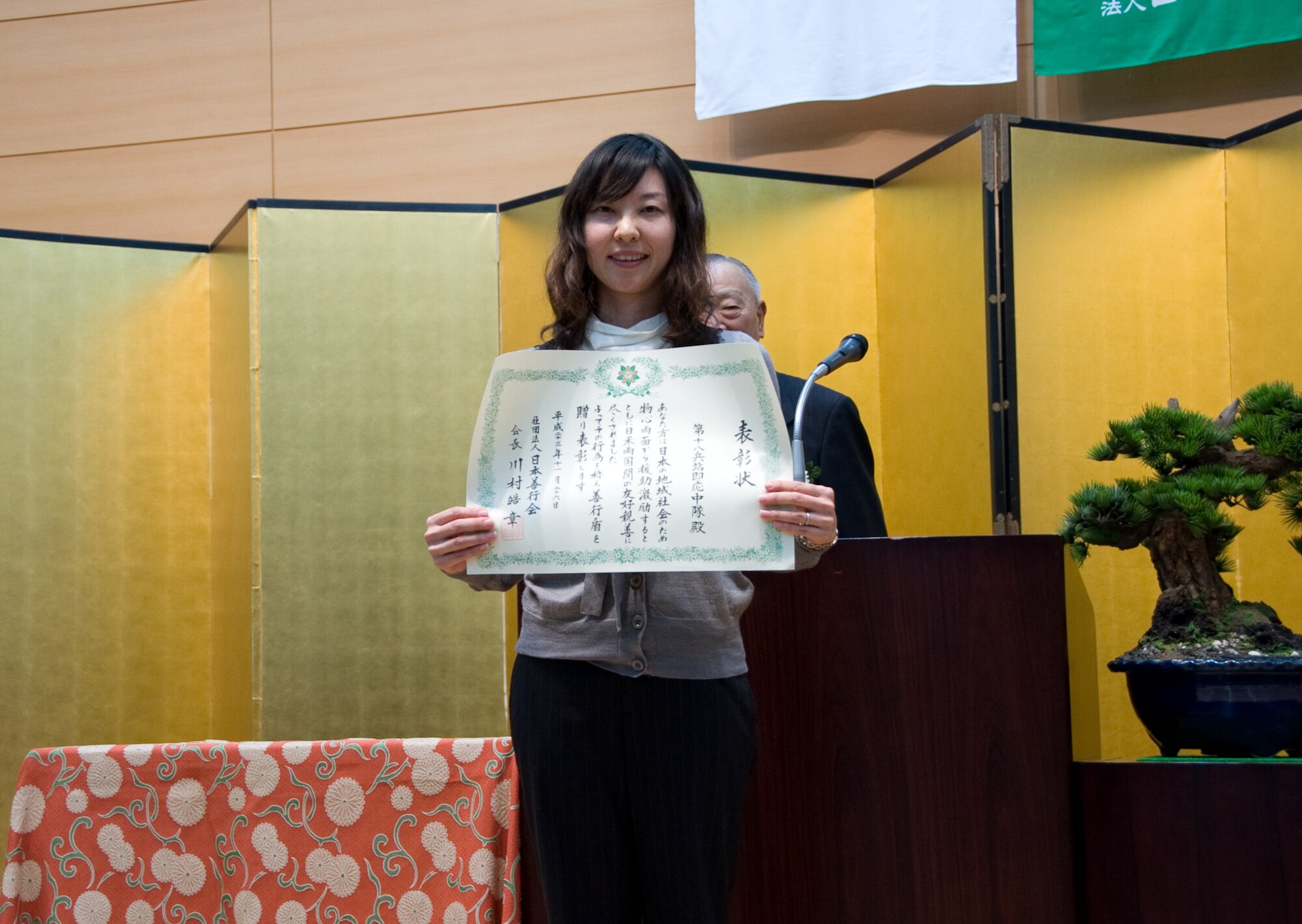 TOKYO, Japan -- Toyokawa Sonoe, 18th Logistics Readiness Squadron at Kadena Air Base, Japan, receives a Good Deed Award at the Meiji Shrine in Tokyo, Japan, Nov. 26, 2011. The Good Deed Association is a non-profit organization under the management of the Cabinet Office of the Government of Japan. The association is committed to encouraging good conduct and enhancing mutual relationships among the members of the community. (U.S. Air Force photo/Airman 1st Class Krystal M. Garrett)