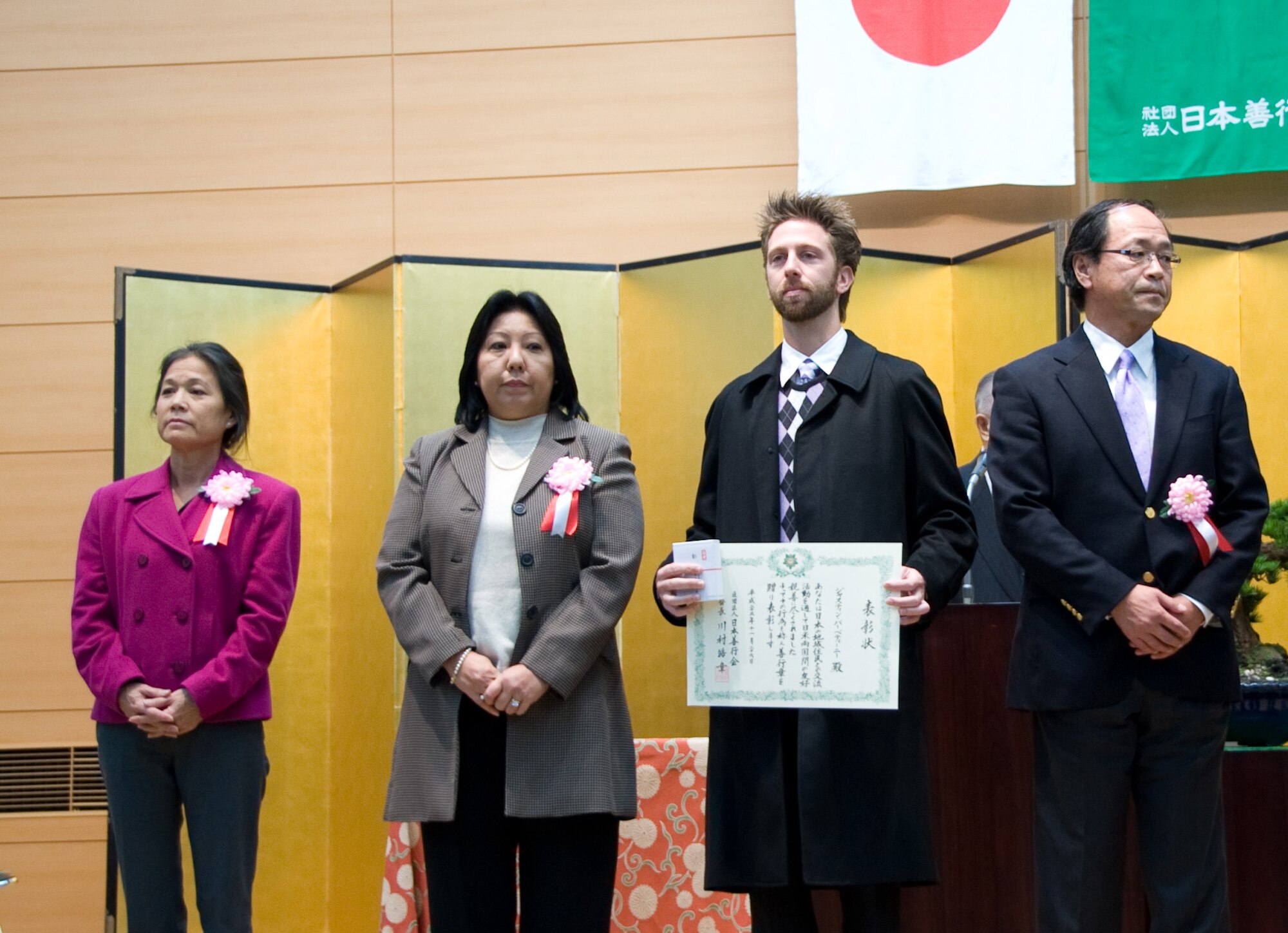 TOKYO, Japan -- Justin Barbettini (third from left), 374th Civil Engineer Squadron at Yokota Air Base, Japan, receives a Good Deed Award at the Meiji Shrine in Tokyo, Japan, Nov. 26, 2011. The Good Deed Association is a non-profit organization under the management of the Cabinet Office of the Government of Japan. The association is committed to encouraging good conduct and enhancing mutual relationships among the members of the community. (U.S. Air Force photo/Airman 1st Class Krystal M. Garrett)