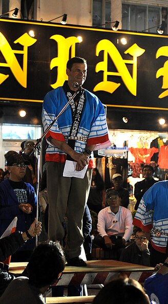 U.S. Air Force Brig. Gen. Matt Molloy, 18th Wing commander, speaks to the crowd at the Okinawa International Carnival, Nov. 28. The carnival included a parade, local food and a giant tug-of-war competition. (U.S. Air Force photo by Airman 1st Class Brooke P. Beers/Released) 
