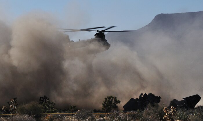 U.S. Air Force Airmen, 820th RED HORSE Squadron airborne flight, prepare to sling load a connex box to a CH-47 Chinook from the Army National Guard, Stockton, Calif., during a peacetime operation Nov. 9, 2011, in the Nevada Test and Training Range.  The sling load training and air assault certification of 820th RHS airborne flight Airmen proved crucial in the success of the quick-response operation. (U.S. Air Force photo by Tech. Sgt. Bob Sommer/Released)