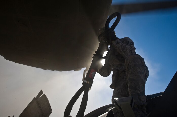 U.S. Air Force Staff Sgt. Ian Zerby, 820th RED HORSE Squadron airborne flight member, prepares to rig a connex box for a sling-load as a CH-47 Chinook from the Army National Guard, Stockton, Calif., hovers overhead during a peacetime operation Nov. 9, 2011, in the Nevada Test and Training Range. The sling load training and air assault certification of 820th RHS airborne flight Airmen proved crucial in the success of the quick-response operation. (U.S. Air Force photo by Airman 1st Class Daniel Hughes/Released)
