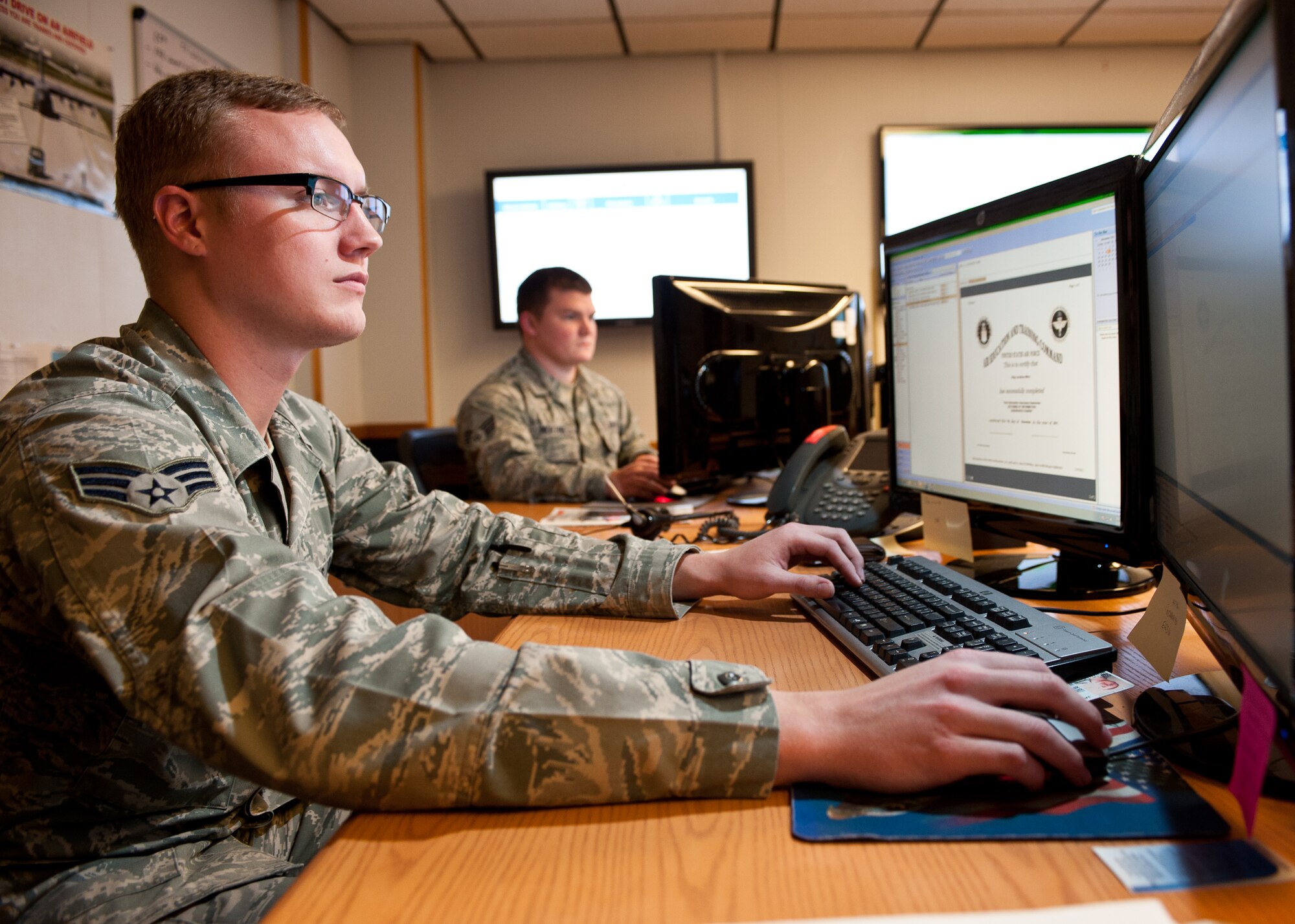 Senior Airman Phillip McNamara, 28th Communications Squadron client systems technician, creates tickets for customers on Ellsworth Air Force Base, S.D., Nov. 9, 2011. McNamara is getting involved in the community by earning the lead role in a play for the Black Hills Community Theatre. (U.S. Air Force photo by Airman Alystria Maurer/Released)