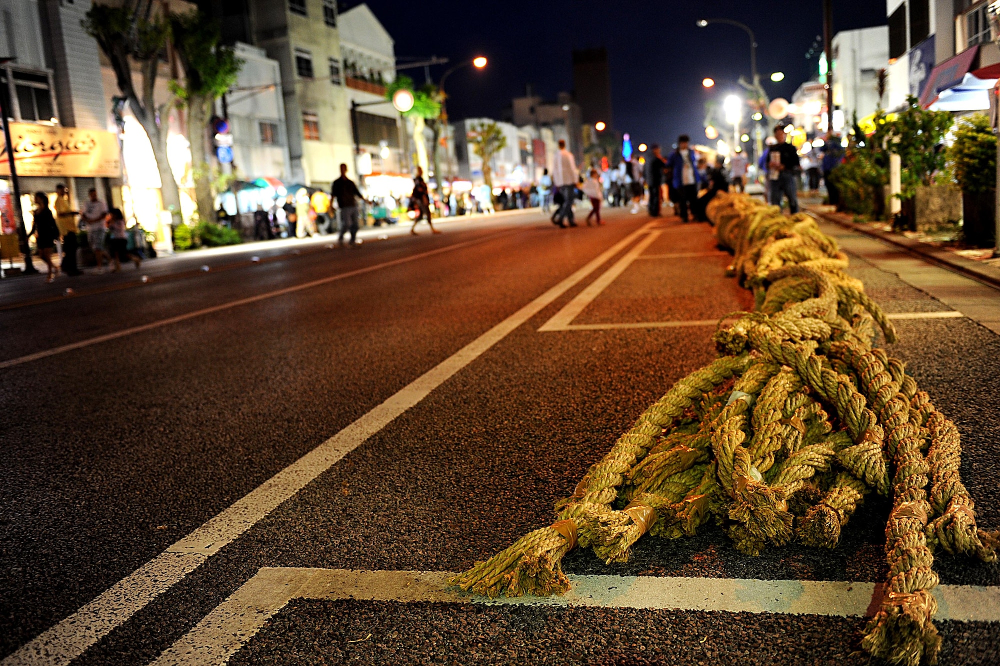 The giant rope for the tug-of-war contest lays on Gate 2 Street at the start of the Okinawa International Carnival, Nov. 28, 2011. The carnival is for both Americans and Okinawans to come together and celebrate their friendship.  (U.S. Air Force photo by Airman 1st Class Brooke P. Beers/Released)