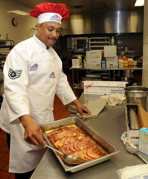 A 2nd Force Support Squadron member prepares ham to be served at the Consolidated Club on Barksdale Air Force Base, La., Nov. 24. More than 50 Barksdale families dined together during a Thanksgiving meal served by base leadership volunteers. Team Barksdale families enjoyed turkey, ham, several side dishes and numerous desserts during the banquet. (U.S. Air Force photo/Senior Airman Amber Ashcraft)(RELEASED)