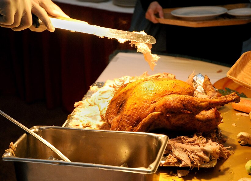 Turkey is served to waiting patrons at the Consolidated Club on Barksdale Air Force Base, La., Nov. 24. More than 50 Barksdale families dined together during a Thanksgiving meal served by base leadership. Team Barksdale enjoyed turkey, ham, several side dishes and numerous desserts during the banquet. (U.S. Air Force photo/Senior Airman Amber Ashcraft)(RELEASED)