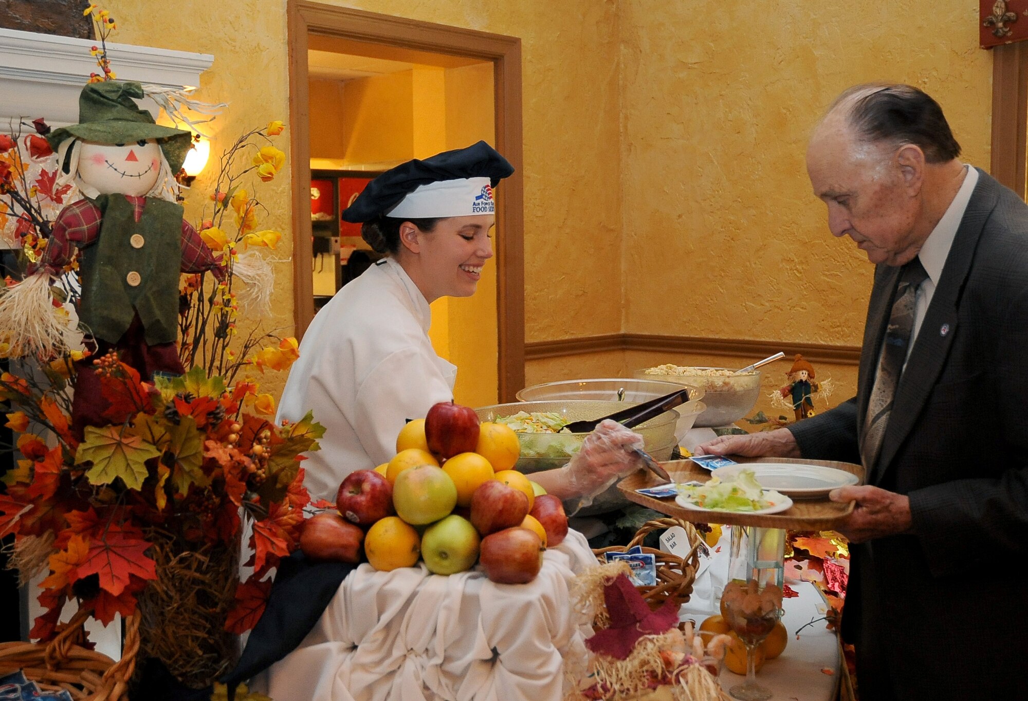 A 2nd Force Support Squadron member assists an Air Force retiree with the salad bar at the Consolidated Club on Barksdale Air Force Base, La., Nov. 24. More than 50 Team Barksdale families enjoyed a Thanksgiving banquet at the Consolidated Club. (U.S. Air Force photo/Senior Airman Amber Ashcraft)(RELEASED)
