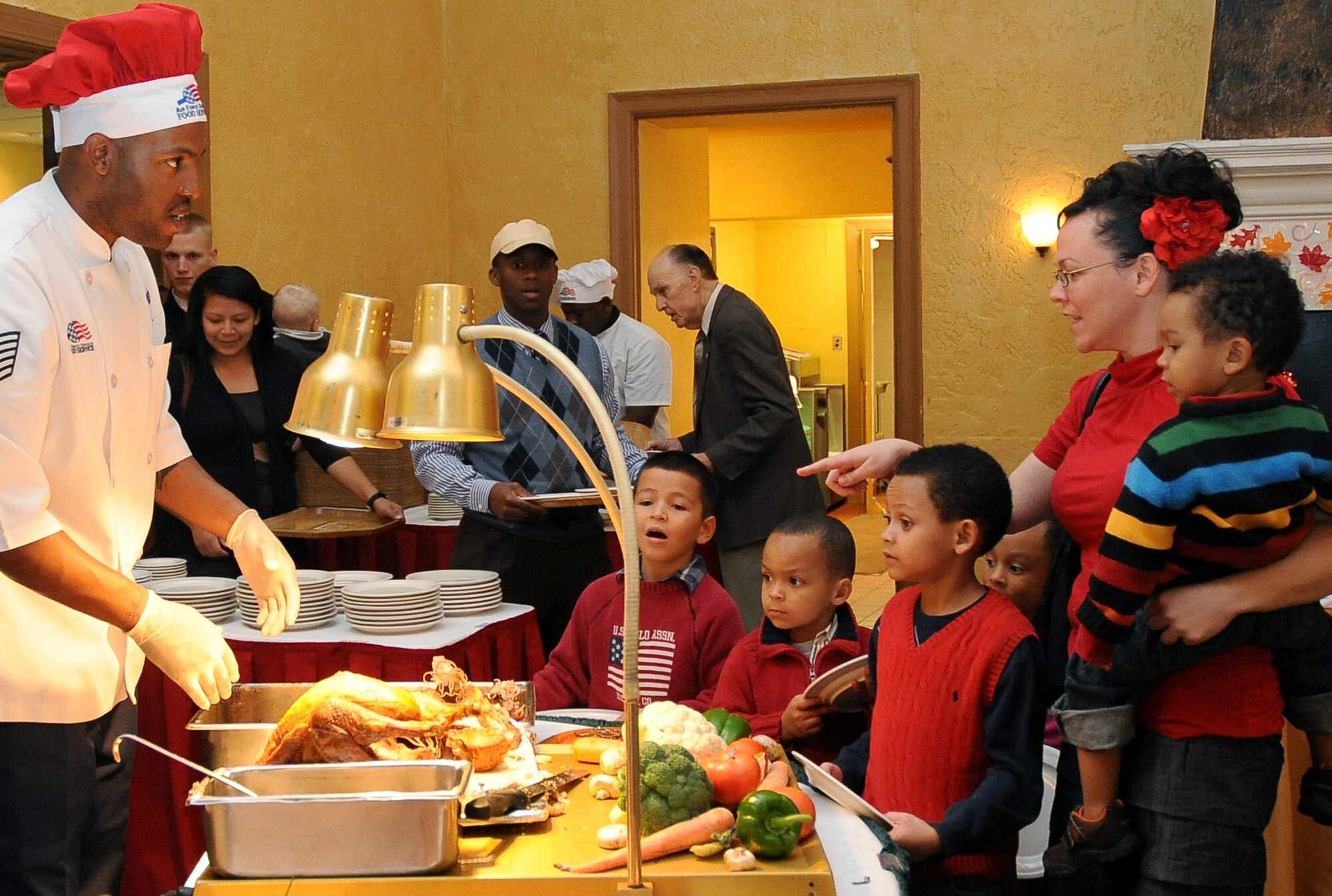 A 2nd Force Support Squadron member serves turkey to a waiting family at the Consolidated Club on Barksdale Air Force Base, La., Nov. 24. More than 50 Team Barksdale families enjoyed a Thanksgiving banquet at the Consolidated Club. (U.S. Air Force photo/Senior Airman Amber Ashcraft)(RELEASED)