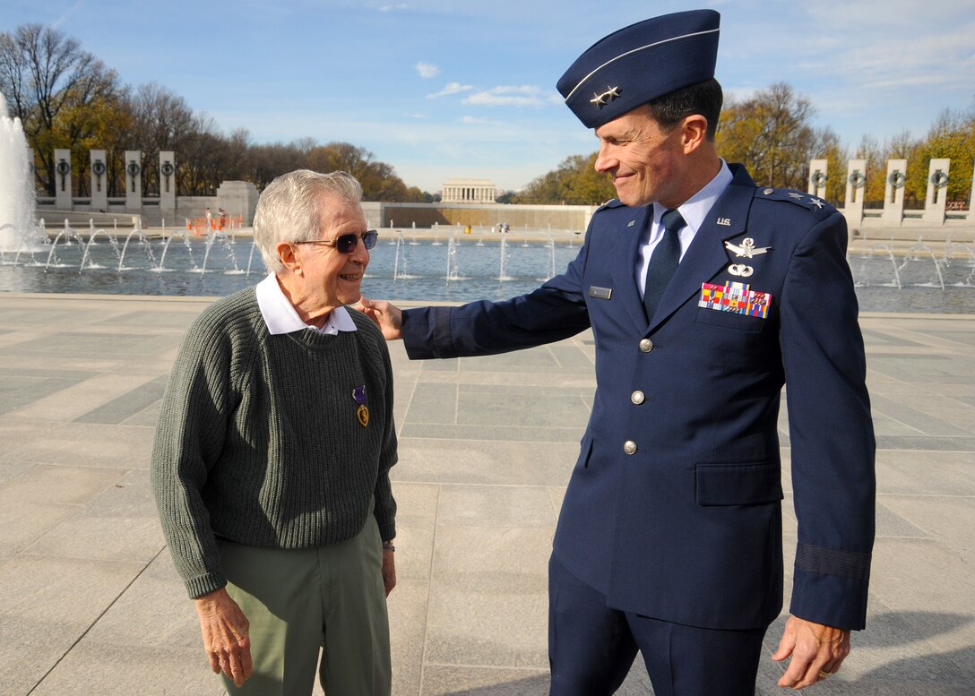 Retired Maj. Gen. Robert M. Worley II presents former 1st Lt. Edward Moppert with a Purple Heart medal Nov. 26, 2011, at the World War II Memorial in Washington, D.C. Moppert was wounded and held as a prisoner of war during World War II, and he was never presented with nor did his records reflect receiving the medal. Worley and members of the Air Force Analysis Assessments & Lessons Learned at the Pentagon, worked with Defense Department officials to get his official records corrected. (U.S. Air Force photo/Master Sgt. Raheem Moore)