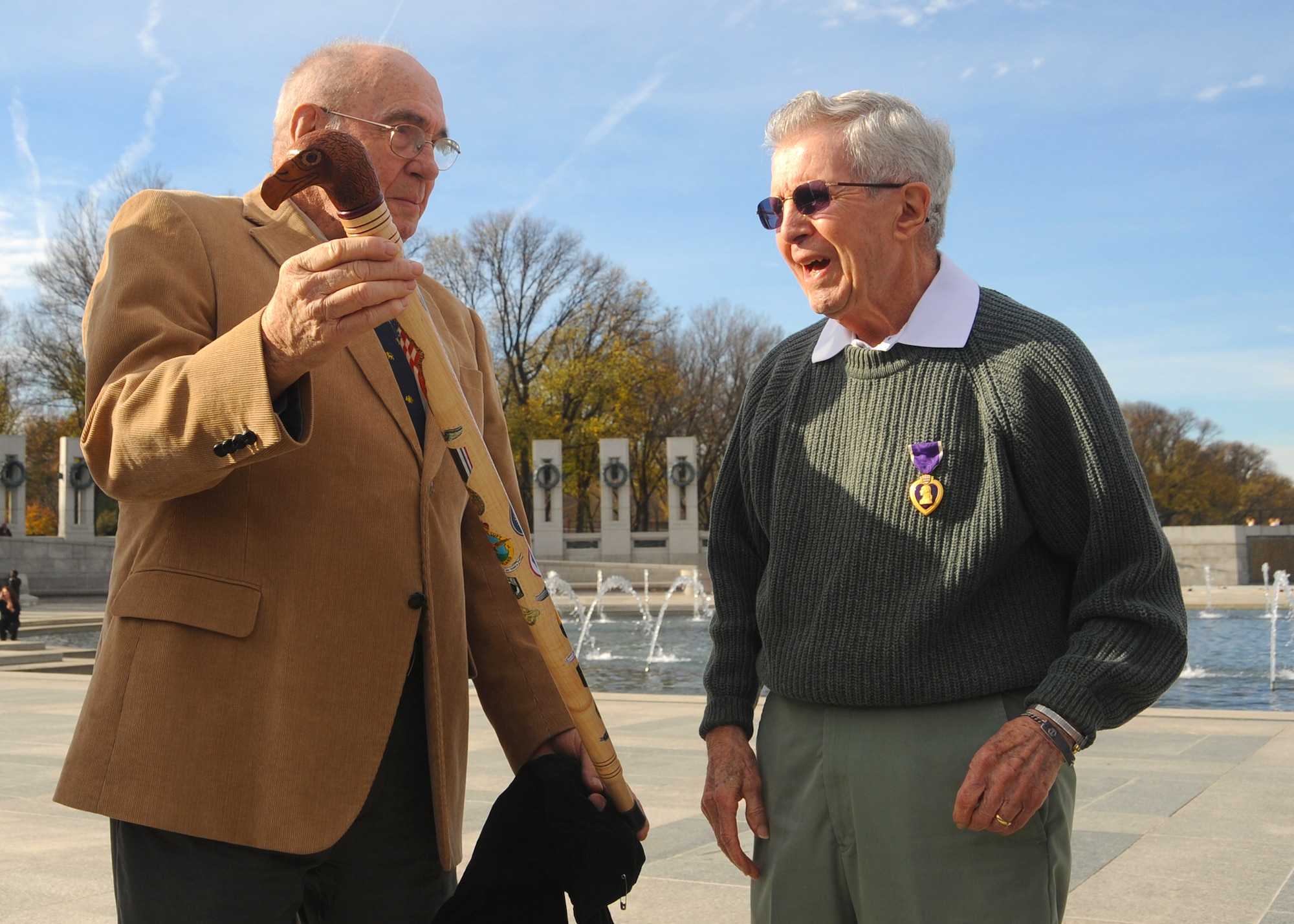 Retired Master Sgt. Hank Cloutier presents former1st Lt. Edward Moppert with an Eagle Cane during Moppert’s Purple Heart medal ceremony Nov. 26, 2011, at the World War II Memorial in Washington. Moppert was wounded and held as a prisoner of war during World War II, and he was never presented with nor did his records reflect receiving the medal. The Eagle Cane is presented to veterans who have received some manner of leg disability from combat related actions. (U.S. Air Force photo/Master Sgt. Raheem Moore)