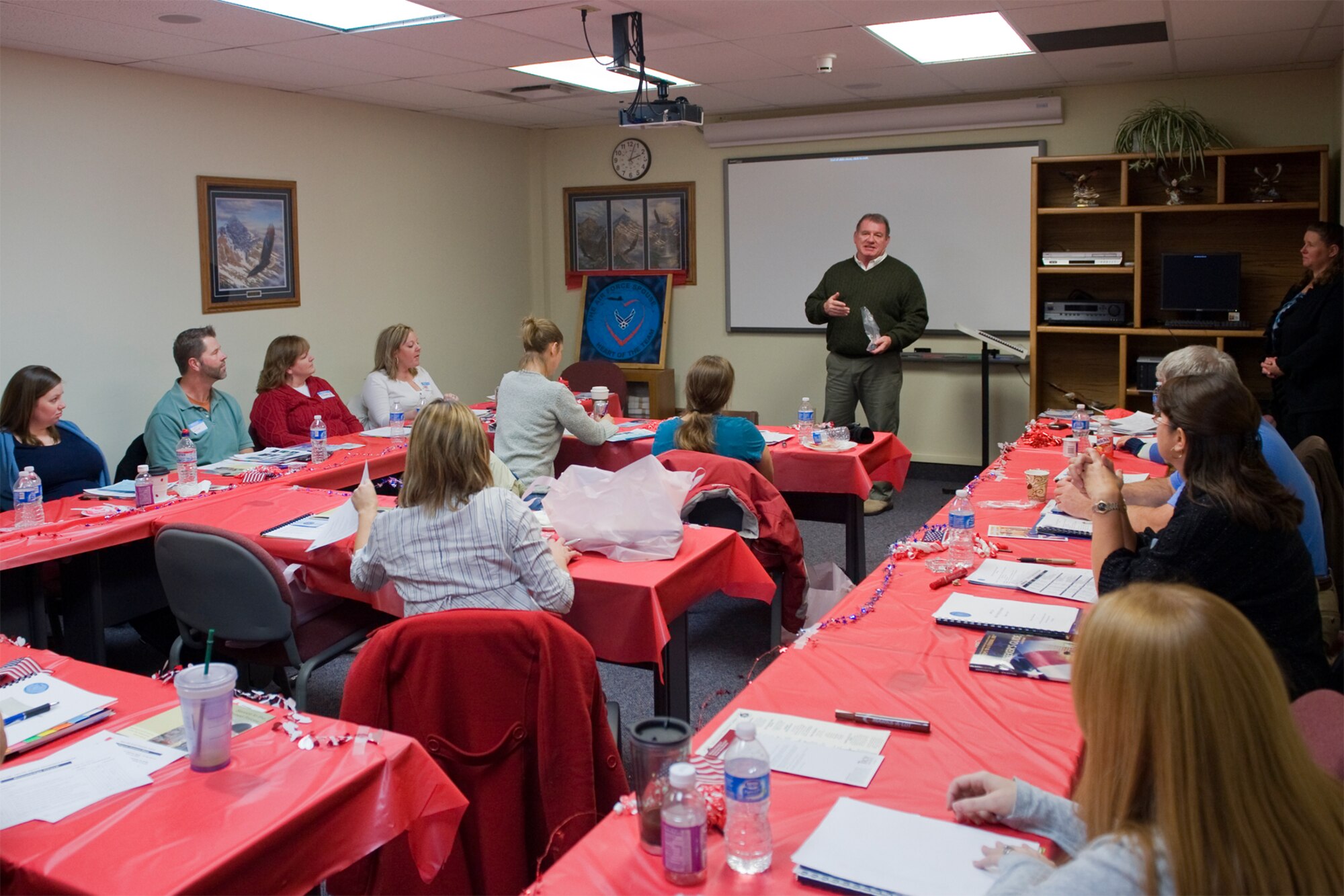 Ric Hamilton, 341st Force Support Squadron deputy commander, thanks the participants who attended the Heart Link orientation class Nov. 18 before giving each one of them a  wing coin on behalf of the Commander, Col. H.B. Brual. (U.S. Air Force photo/Beau Wade)
