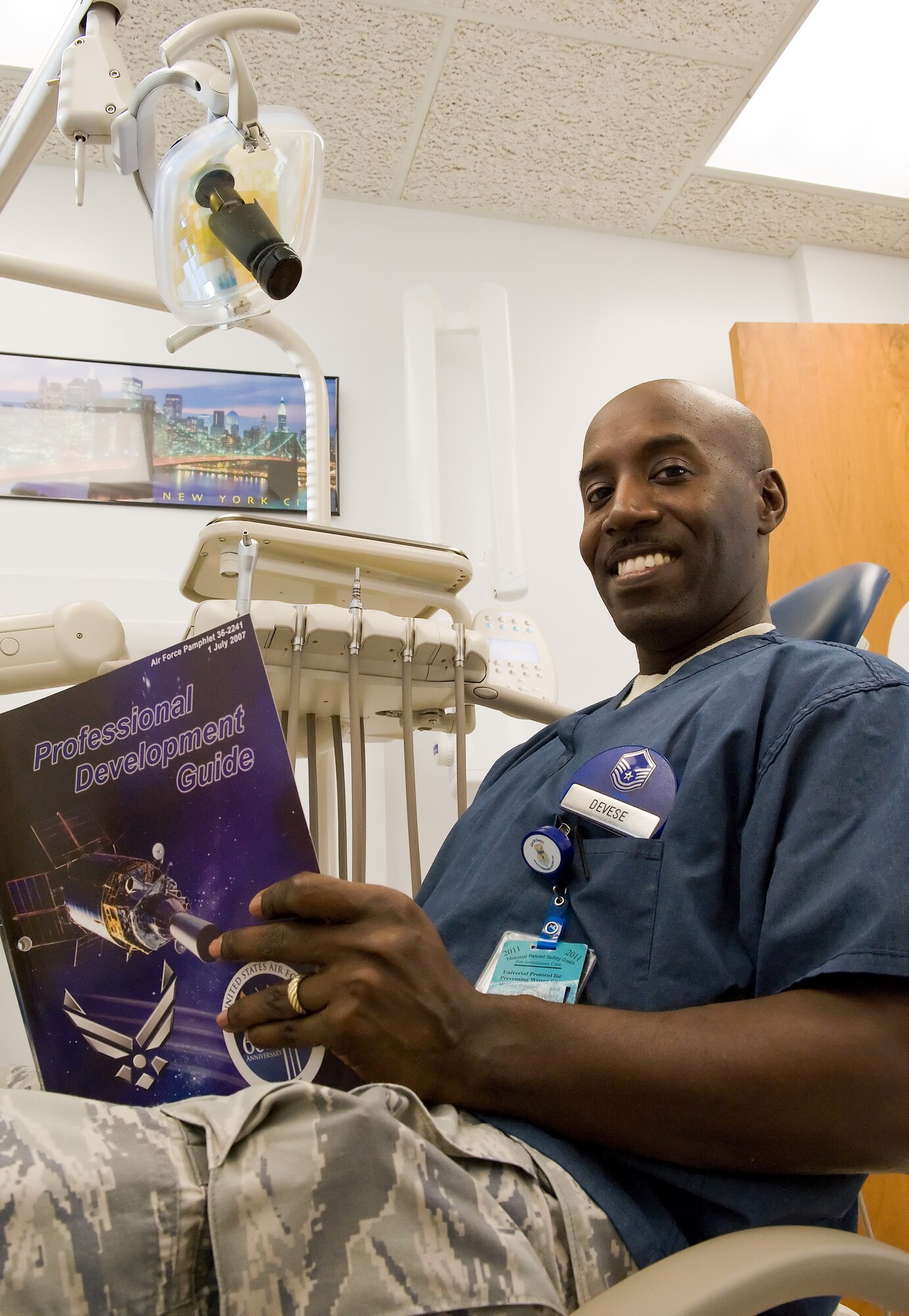 Master Sgt. Eric Devese, Noncommissioned officer in charge of the 436th Dental Squadron Dental Lab, reads the Professional Development Guide Nov. 28, 2011, Dover Air Force Base, Del. Devese was selected for The Situation in the Dec. 2, 2011 edition of The Airlifter. (U.S. Air Force photo by Roland Balik)