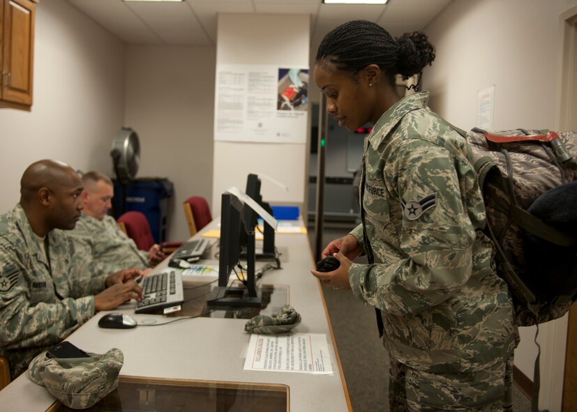 U.S. Air Force Airman 1st Class Careen Lewis, 23rd Equipment Maintenance Squadron, goes through a processing line with the 23rd Logistics Readiness Squadron prior to a deployment at the Deployment Control Center, Moody Air Force Base, Ga., Nov. 23, 2011. Lewis, along with several other Moody Airmen, left for Afghanistan a day before Thanksgiving to support for Operation Enduring Freedom. The DCC is a final processing location before Airmen deploy. (U.S. Air Force photo by Senior Airman Eileen Meier/Released)