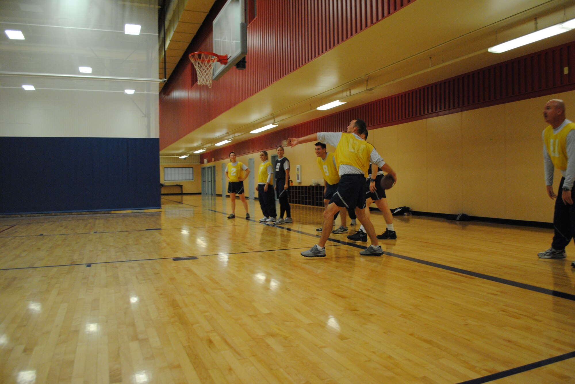 Tech Sgt. Jason White, Weapon Storage Area escort supervisor with the 341st Missile Wing, throws a football at the Fitness and Sports Center as other members of the 341st CPTS and 341st WSA look on during Wingman Day Nov. 18. (U.S. Air Force photo/Airman 1st Class Katrina Heikkinen)