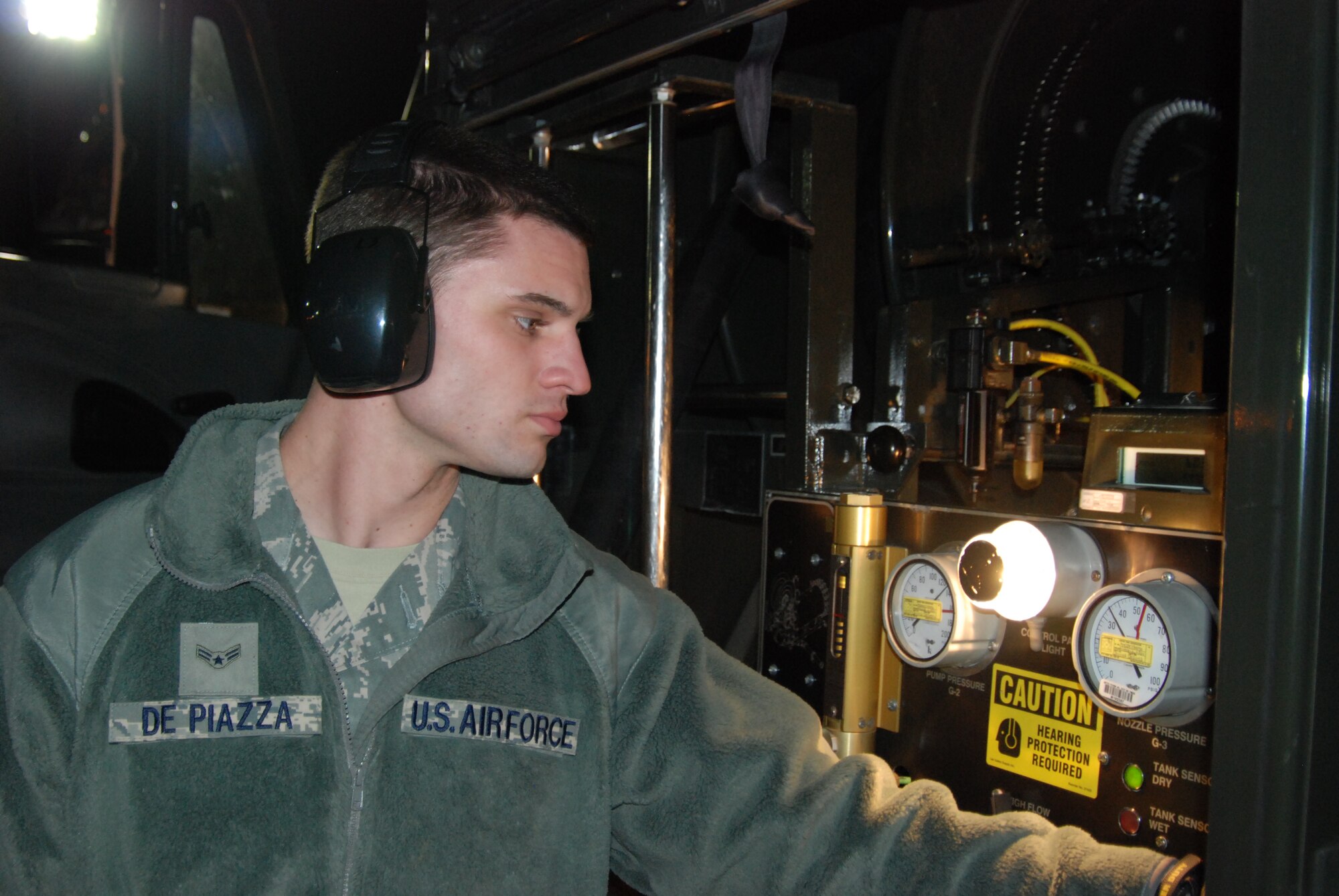 Airman 1st Class Dillon DePiazza monitors gauges while fueling an F-15E Strike Eagle on the flightline, Nov. 22, 2011, at Mountain Home Air Force Base, Idaho. DePiazza is a recent addition to the petroleum oil and lubricants crew, but in his short time has made a positive impact on the mission. (U.S. Air Force photo by Airman 1st Class Shane M. Phipps)