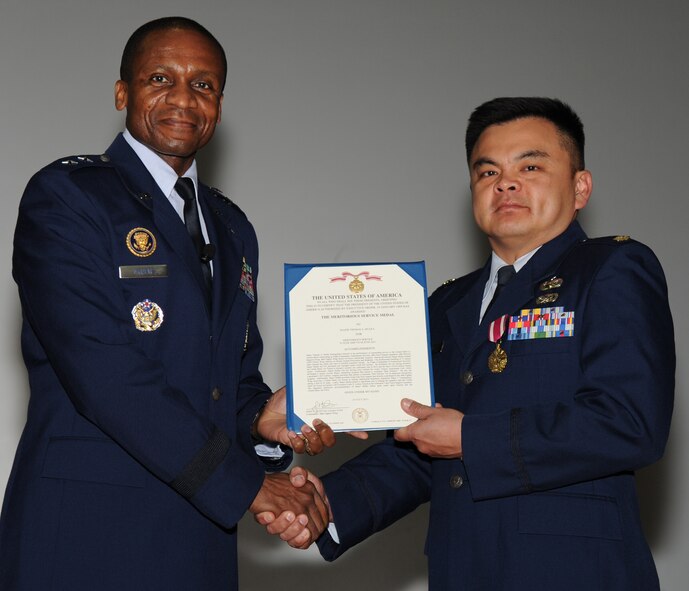 Air Force District of Washington Commander Maj. Gen. Darren McDew presents the Meritorious Service Medal to Maj. Thomas Mulka, finance executive officer, at the Nov. 18 commander’s call on Joint Base Andrews, Md. McDew recognized seven Airmen in AFDW for superior service and support. (U.S. Air Force photo by Staff Sgt. Christopher Ruano)