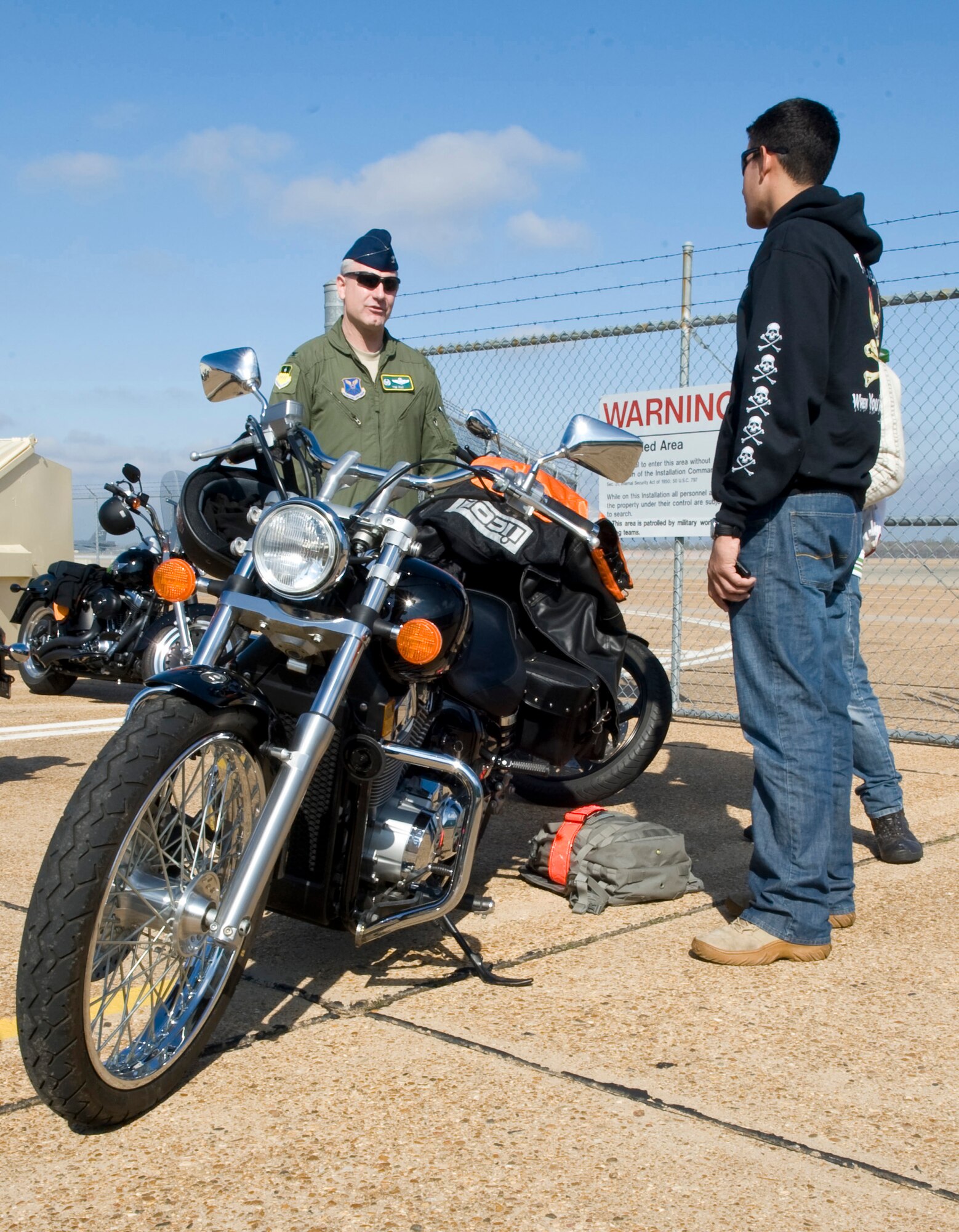 Col. Tim Fay, 2nd Bomb Wing commander, speaks to Senior Airman Raphael Fonseca, 2nd Logistics Readiness Squadron, about motorcycles before a fun ride on Barksdale Air Force Base, La., Nov. 23. Fay spoke with all the motorcycle enthusiasts who showed up for the fun ride. (U.S. Air Force photo/Airman 1st Class Benjamin Gonsier)(RELEASED)