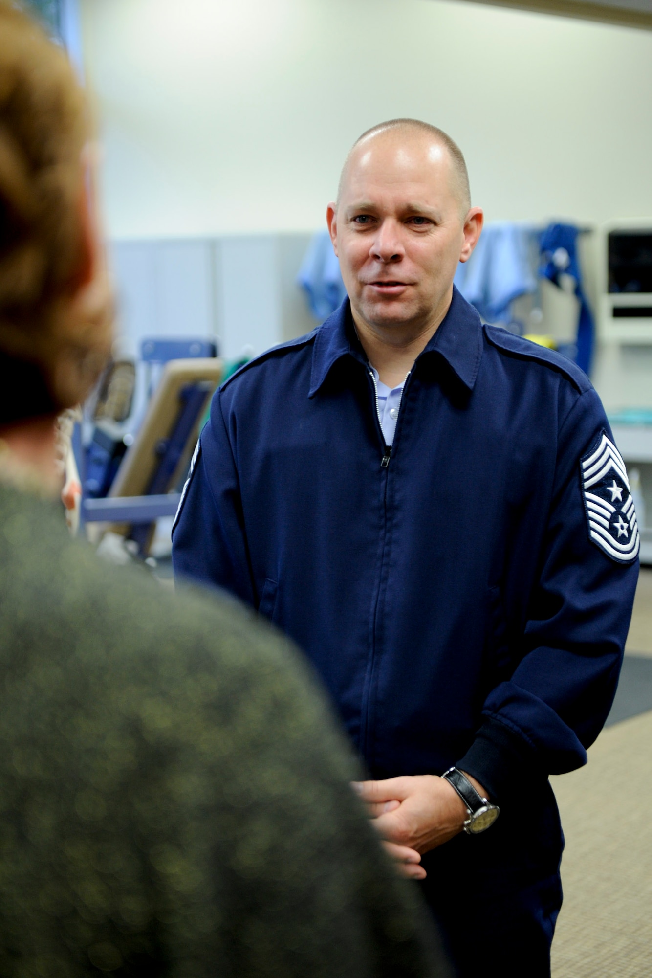 VANDENBERG AIR FORCE BASE, Calif. -- Chief Master Sgt. Dennis L. Vannorsdall, the 14th Air Force command chief, speaks with a Health and Wellness Center employee at the medical clinic here Monday, Nov. 28, 2011. Vannorsdall was touring the 30th Medical Group as part of a base integration tour for his recent arrival as top enlisted member of the 14th Air Force. (U.S. Air Force photo/Staff Sgt. Levi Riendeau)