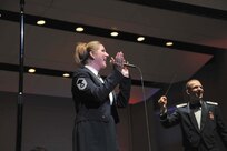 First Lt. Joe Hanson, conducts while Master Sgt. Nancy Poffenbarger, U.S. Air Force Band of the West vocalist, leads the audience in a series of patriotic melodies at the Majestic Theater Nov. 13. (U.S. Air Force photo/Alan Boedeker)