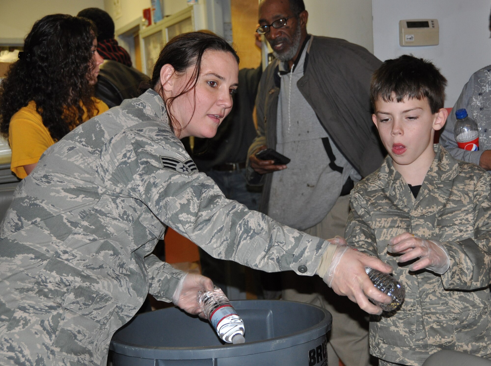 JOINT BASE MCGUIRE-DIX-LAKEHURST, N.J. -  Senior Airman Michele Zuffanti and her son, Micah, are two of 20 volunteers from the 514th Air Mobility Wing, serves dinner Nov. 26 to more than 200 homeless guests of Chosen 300 Ministries Inc., located in Philadlelphia, Pa. Numerous Air Force Reserve volunteers from Joint Base McGuire-Dix-Lakehurst, N.J., spent their Thanksgiving Holiday giving back to others in the local community. (U.S. Air Force photo/Master Sgt. Donna T. Jeffries)