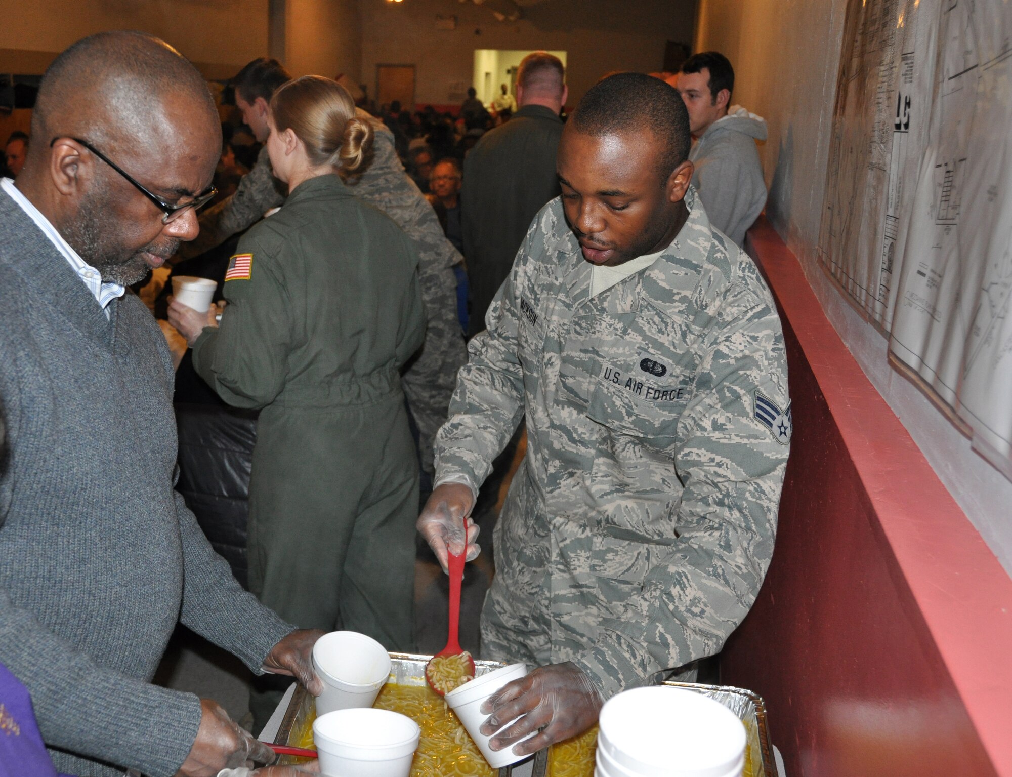 JOINT BASE MCGUIRE-DIX-LAKEHURST, N.J. -  Senior Airman Andre Jackson, one of 20 volunteers from the 514th Air Mobility Wing, serves dinner Nov. 26 to more than 200 homeless guests of Chosen 300 Ministries Inc., located in Philadlelphia, Pa. Numerous Air Force Reserve volunteers from Joint Base McGuire-Dix-Lakehurst, N.J., spent their Thanksgiving Holiday giving back to others in the local community. (U.S. Air Force photo/Master Sgt. Donna T. Jeffries)