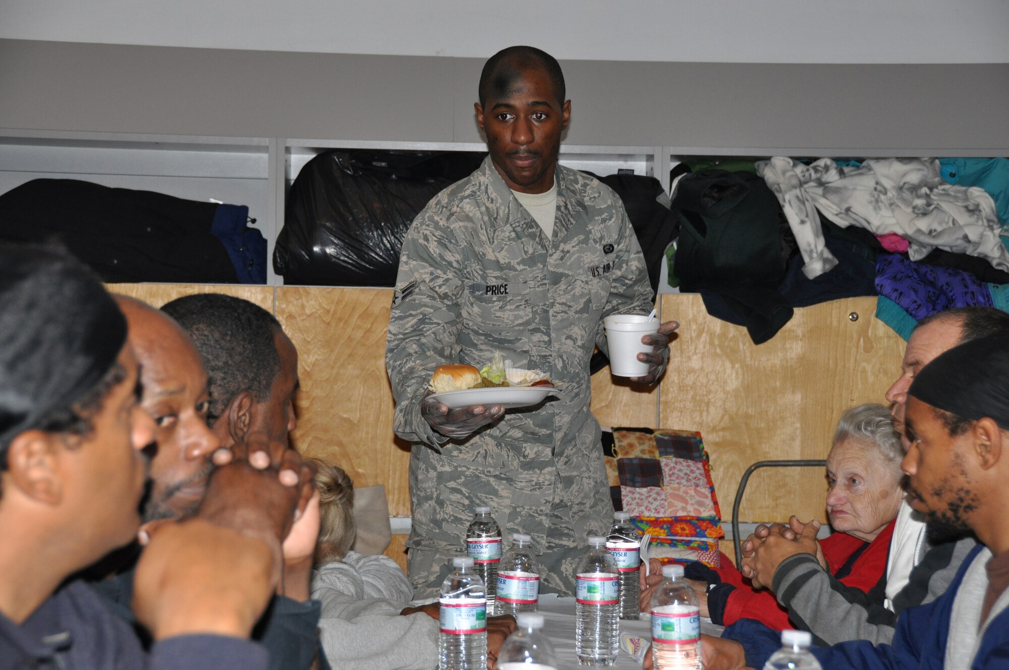 JOINT BASE MCGUIRE-DIX-LAKEHURST, N.J. -  Airman 1st Class Vaughn Price, one of 20 volunteers from the 514th Air Mobility Wing, serves dinner Nov. 26 to more than 200  homeless guests of Chosen 300 Ministries Inc., located in Philadlelphia, Pa. Numerous Air Force Reserve volunteers from Joint Base McGuire-Dix-Lakehurst, N.J., spent their Thanksgiving Holiday giving back to others in the local community. (U.S. Air Force photo/Master Sgt. Donna T. Jeffries)