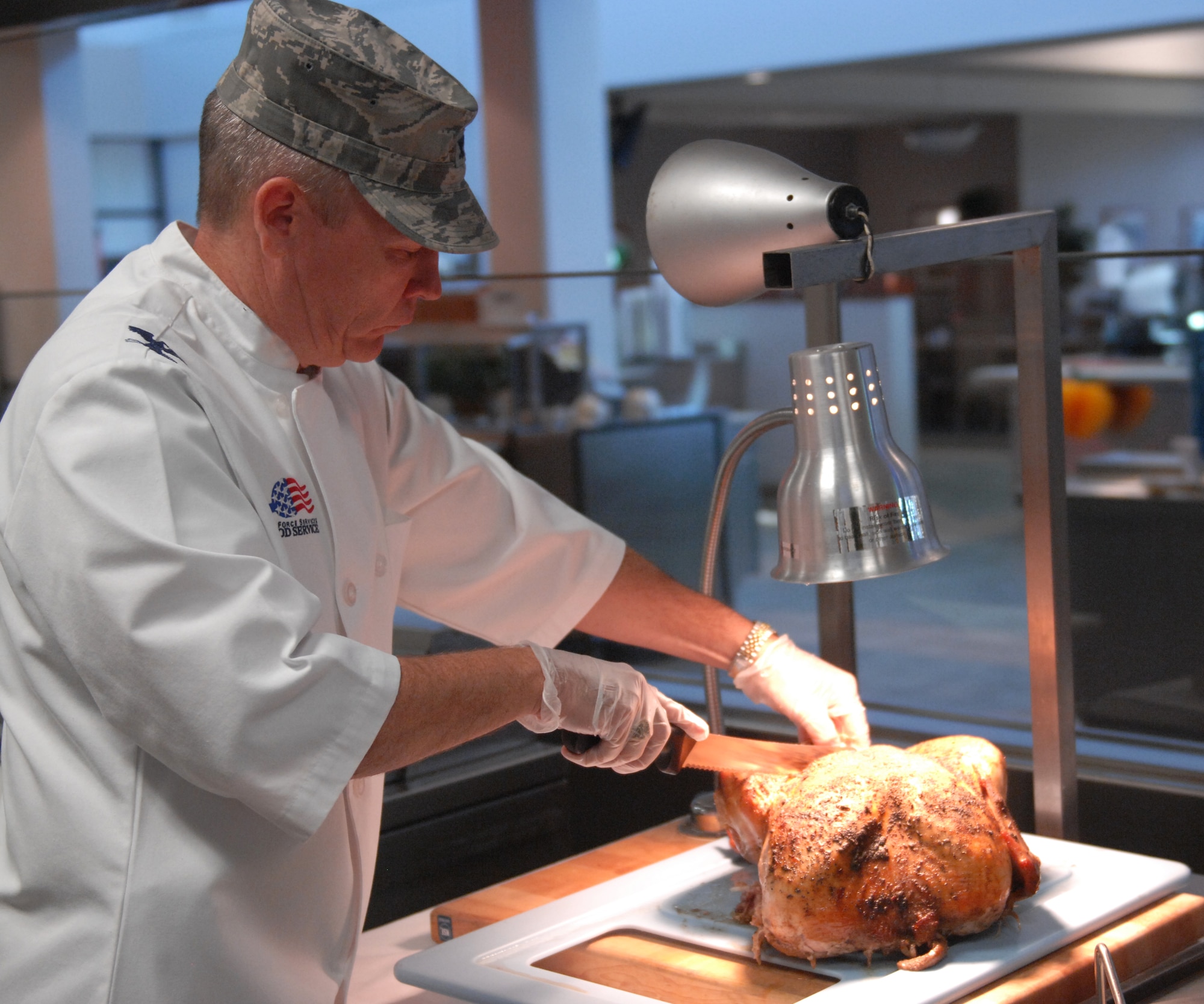 U.S. Air Force Col. Walter Fulda, 20th Mission Support Group commander, helps slice a turkey for Airmen at the dining facility, at Shaw Air Force Base, S.C., Nov. 24, 2011. Every year commanders and chief master sergeants volunteer to serve at the Shaw dining facility for those who could not make it home to family and friends for Thanksgiving. (U.S. Air Force photo by Airman 1st Class Blake Hubbard/Released)