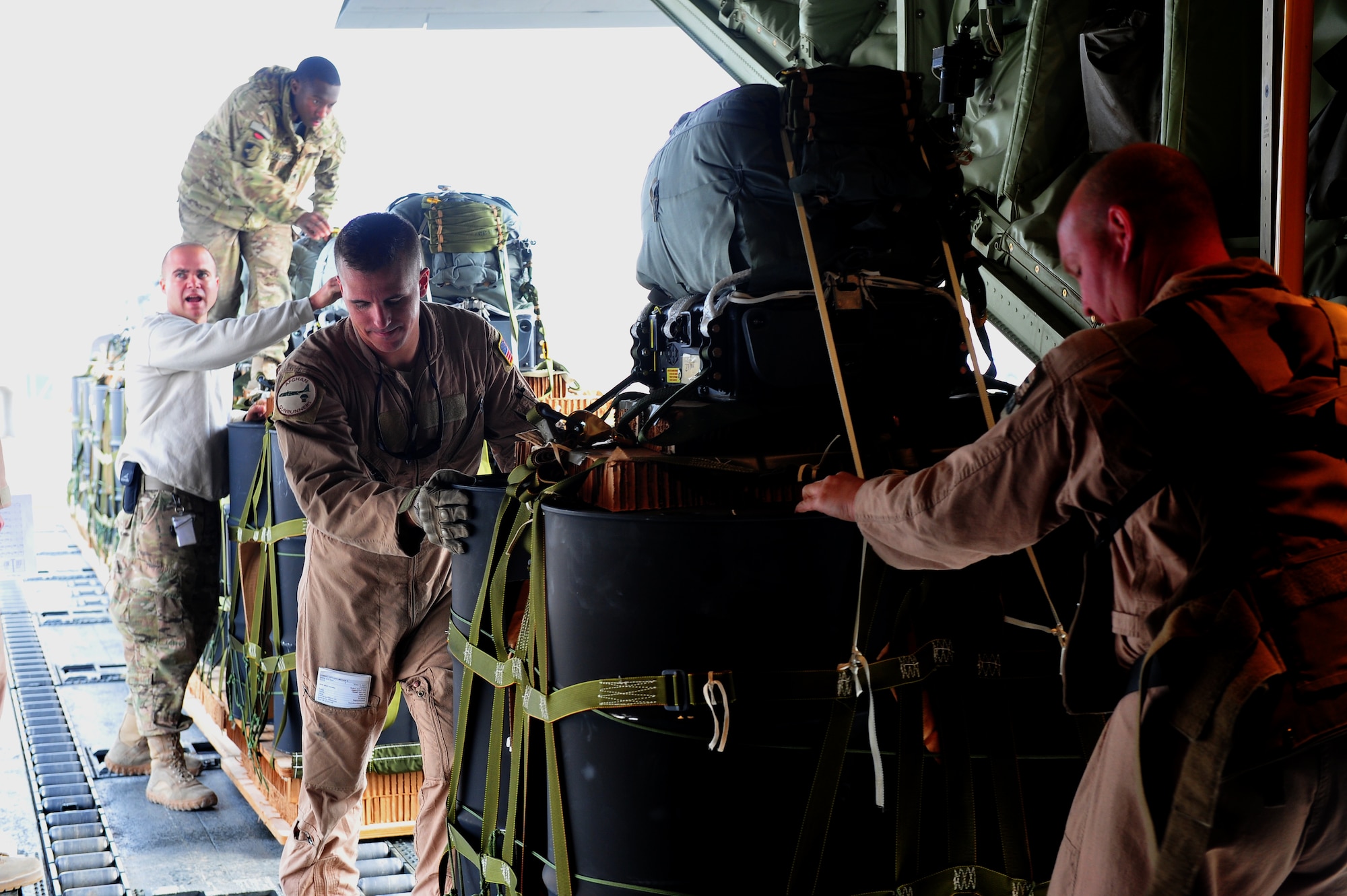 Air Force and Army personnel use a K-loader to load the Joint Precision Air Drop system bundles onto a C-130J Hercules, Bagram Airfield, Afghanistan, Nov. 27, 2011. The JPAD system uses a Global Positioning System navigation to guide parachute bundles to precise drop zones, minimizing collateral damage, troops' ground travel, and the vulnerability of the aircraft. (U.S. Air Force photo/Senior Airman Tyler Placie)