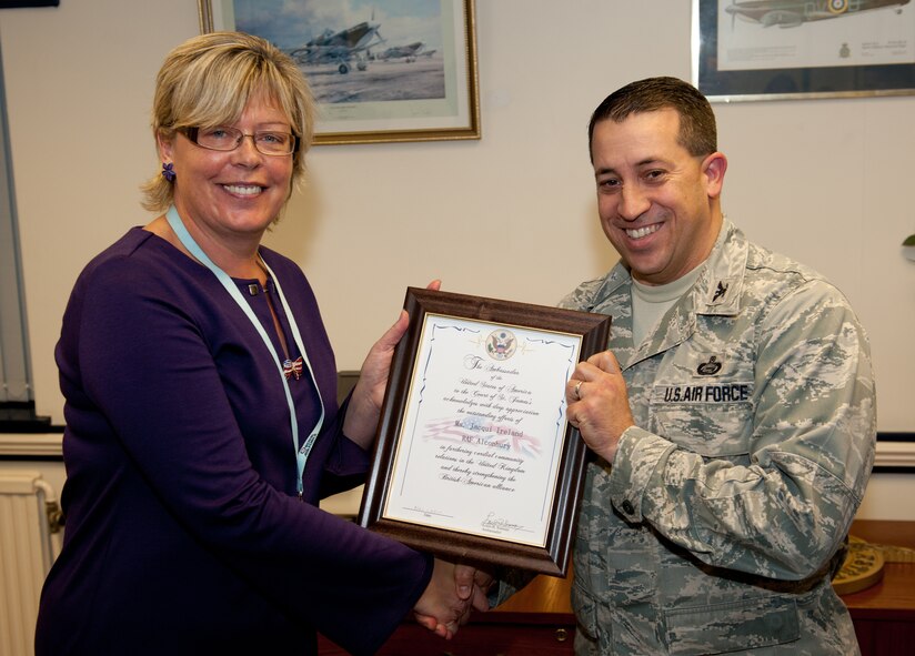 RAF ALCONBURY, United Kingdom - Col. Brian Kelly, 501st Combat Support Wing commander, presents Jacqui Ireland, 423rd Air Base Group Community Relations Advisor, with the Ambassador’s Award recognizing her exceptional contributions to British-American community relations.  Recipients are chosen by the U.S. Ambassador to the United Kingdom. (U.S. Air Force photo by Tech. Sgt. John Barton)