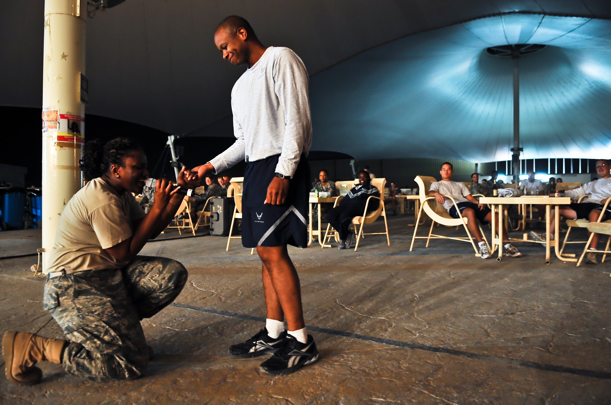 Tech. Sgt. Amber Grimes, U.S. Air Forces Central Command band ‘Top Cover’ lead vocalist, serenades Capt. Hershey Langston, U.S. Forces Afghanistan communications planner, during a farewell concert at the Memorial Plaza Nov. 25, 2011, at an undisclosed location in Southwest Asia. During its deployment, the band toured seven countries and made more than 80 appearances, playing such songs as “Forget you” by Cee-Lo Green, “R.E.S.P.E.C.T” by Aretha Franklin, “Don’t Stop Believing” by Journey and “Freebird” by Lynyrd Skynyrd. Grimes, a native of Columbus, Ga., is deployed from Joint Base Elmendorf-Richardson, Alaska. Langston, a native of Los Angeles, Calif., is deployed from Minot Air Force Base, N.D. (U.S. Air Force photo/Senior Airman Paul Labbe)
