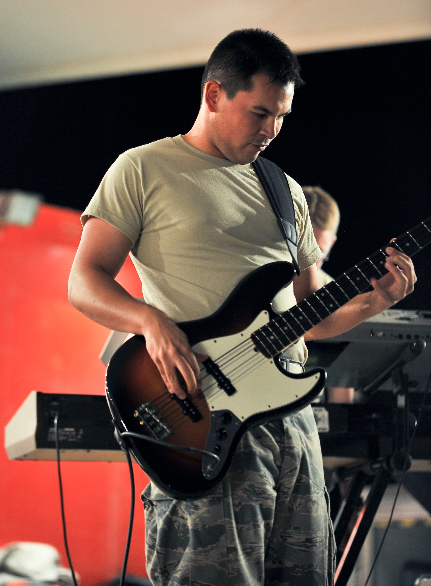Airman 1st Class Philip Runge, U.S. Air Forces Central Command band ‘Top Cover’ bassist, performs during a farewell concert at the Memorial Plaza Nov. 25, 2011, at an undisclosed location in Southwest Asia. During its deployment, the band toured seven countries and made more than 80 appearances, playing such songs as “Forget you” by Cee-Lo Green, “R.E.S.P.E.C.T” by Aretha Franklin, “Don’t Stop Believing” by Journey and “Freebird” by Lynyrd Skynyrd. Runge, a native of Garland, Texas, is deployed from Joint Base Elmendorf-Richardson, Alaska. (U.S. Air Force photo/Senior Airman Paul Labbe)