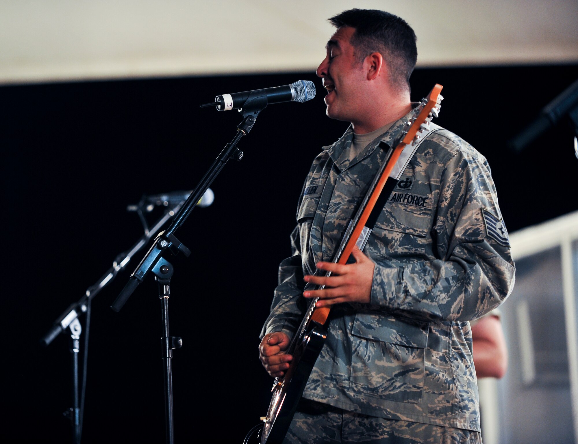 Staff Sgt. Justin Allen, U.S. Air Forces Central Command band ‘Top Cover’ lead vocalist, performs during a farewell concert at the Memorial Plaza Nov. 25, 2011, at an undisclosed location in Southwest Asia. During its deployment, the band toured seven countries and made more than 80 appearances, playing such songs as “Forget you” by Cee-Lo Green, “R.E.S.P.E.C.T” by Aretha Franklin, “Don’t Stop Believing” by Journey and “Freebird” by Lynyrd Skynyrd. Allen, a native of Indianapolis, Ind., is deployed from Joint Base Elmendorf-Richardson, Alaska. (U.S. Air Force photo/Senior Airman Paul Labbe)