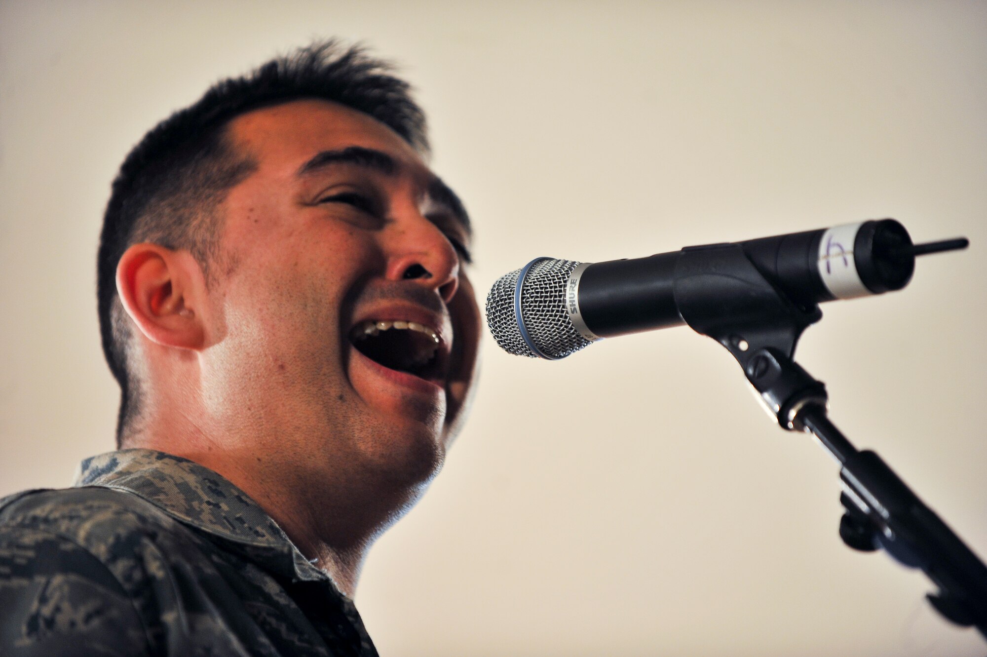 Staff Sgt. Justin Allen, U.S. Air Forces Central Command band ‘Top Cover’ lead vocalist, performs during a farewell concert at the Memorial Plaza Nov. 25, 2011, at an undisclosed location in Southwest Asia. During its deployment, the band toured seven countries and made more than 80 appearances, playing such songs as “Forget you” by Cee-Lo Green, “R.E.S.P.E.C.T” by Aretha Franklin, “Don’t Stop Believing” by Journey and “Freebird” by Lynyrd Skynyrd. Allen, a native of Indianapolis, Ind., is deployed from Joint Base Elmendorf-Richardson, Alaska. (U.S. Air Force photo/Senior Airman Paul Labbe)