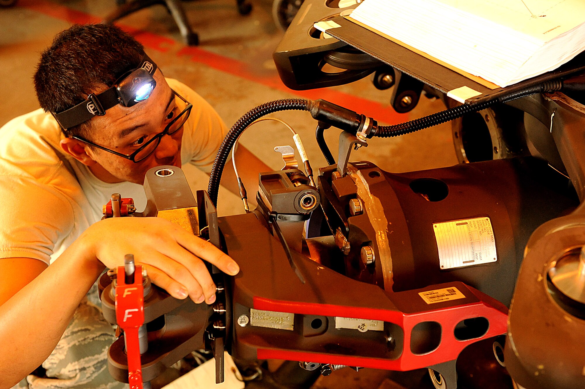 U.S. Air Force Airman 1st Class Robin Lu, 718th Aircraft Maintenance Squadron crew chief, inspects the flap stop of a U.S. Air Force HH-60G Pave Hawk helicopter for corrosion build up on Kadena Air Base, Japan, Nov. 2, 2011. The 718th Aircraft Maintenance Squadron provides the only aerial refueling, air battle management and combat search and rescue assets in the Asian and Western Pacific region. (U.S. Air Force photo by Airman 1st Class Justin Veazie/Released)