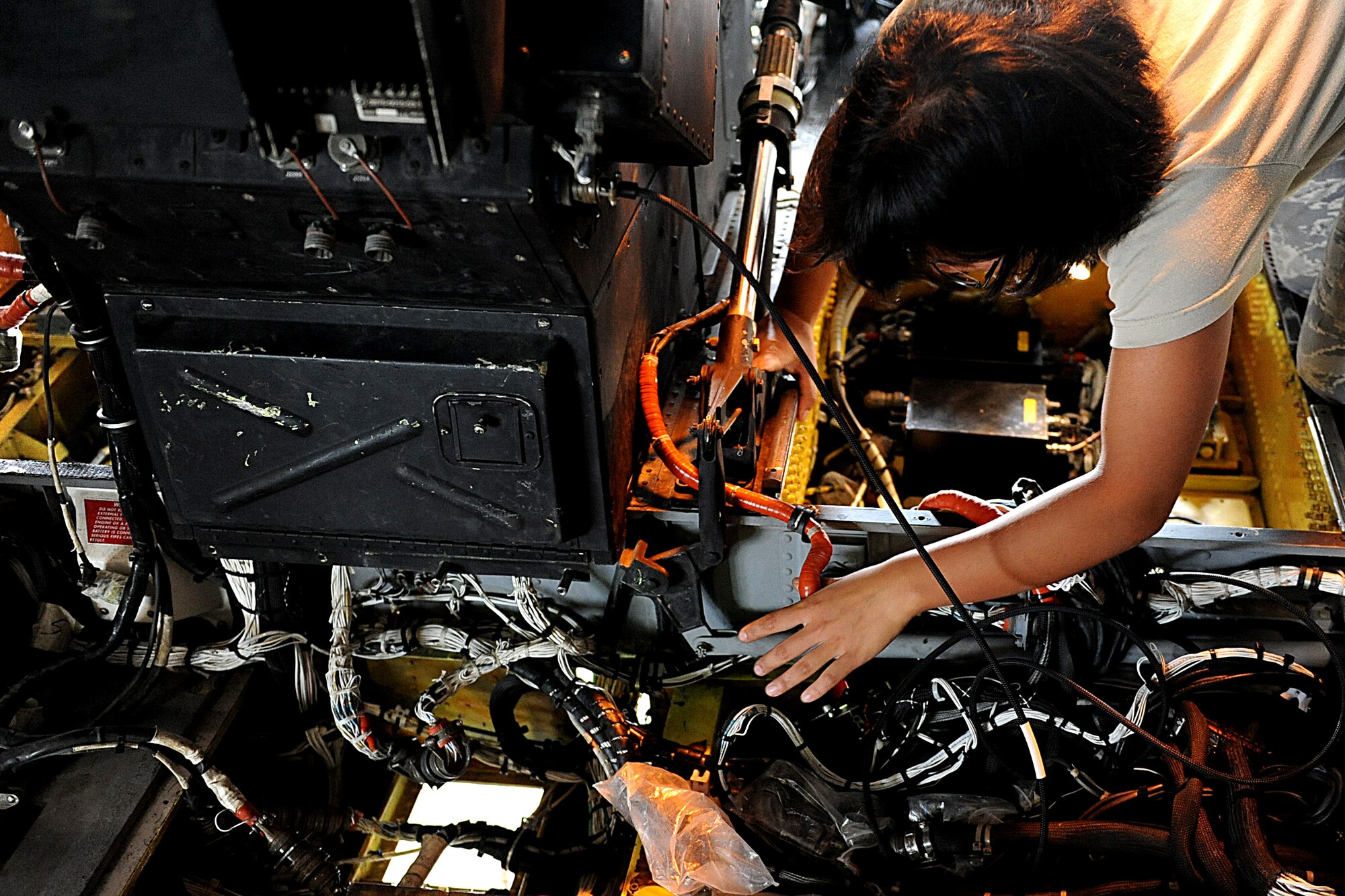 U.S. Air Force Senior Airman Grace Gonzaga, 718th Aircraft Maintenance Squadron electrical environmentalist, traces a wire that runs from the tail end of an U.S. Air Force HH-60G Pave Hawk helicopter to the nose on Kadena Air Base, Japan, Nov. 2, 2011. The 718th AMXS is responsible for maintaining U.S. Air Force KC-135R/T Stratotanker aerial refueling aircraft, HH-60G Pave Hawk helicopter and E-3 Sentry (AWACS) surveillance aircraft. (U.S. Air Force photo by Airman 1st Class Justin Veazie/Released)