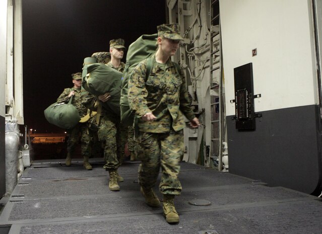 Marines and Sailors of the 24th Marine Expeditionary Unit embark on the Navy’s Amphibious Assault Ship, the USS Iwo Jima (LHD 7) docked at Naval Base Norfolk, Va. Nov. 28, prior to departing for Composite Unit Training Exercise (COMPTUEX). The exercise is scheduled to take place Nov. 28 to Dec. 21 to develop cohesion between the 24th Marine Expeditionary Unit and Amphibious Squadron 8 (PHIBRON-8) in conducting amphibious operations, crisis response, and limited contingency operations while operating from the sea.