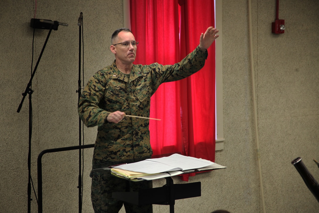 Chief Warrant Officer 4 Robert Szabo, the band officer, with Marine Wing Headquarters Squadron 2, enthusiastically directs the band while they practice for the 2011 Christmas Concert, Nov. 29. The concert will be held at the Marine Corps Air Station Cherry Point Theater Dec. 9.