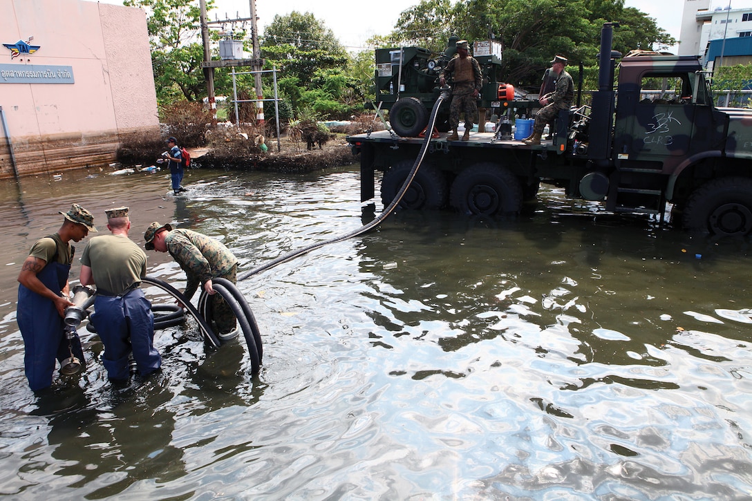 Marines with 3rd Marine Logistics Group prepare to pump flood water from affected areas of the Don Mueang International Airport in Bangkok Nov. 29. The III Marine Expeditionary Force Flood Relief Command Element directed personnel assisting the Royal Government of Thailand with flood-relief efforts.